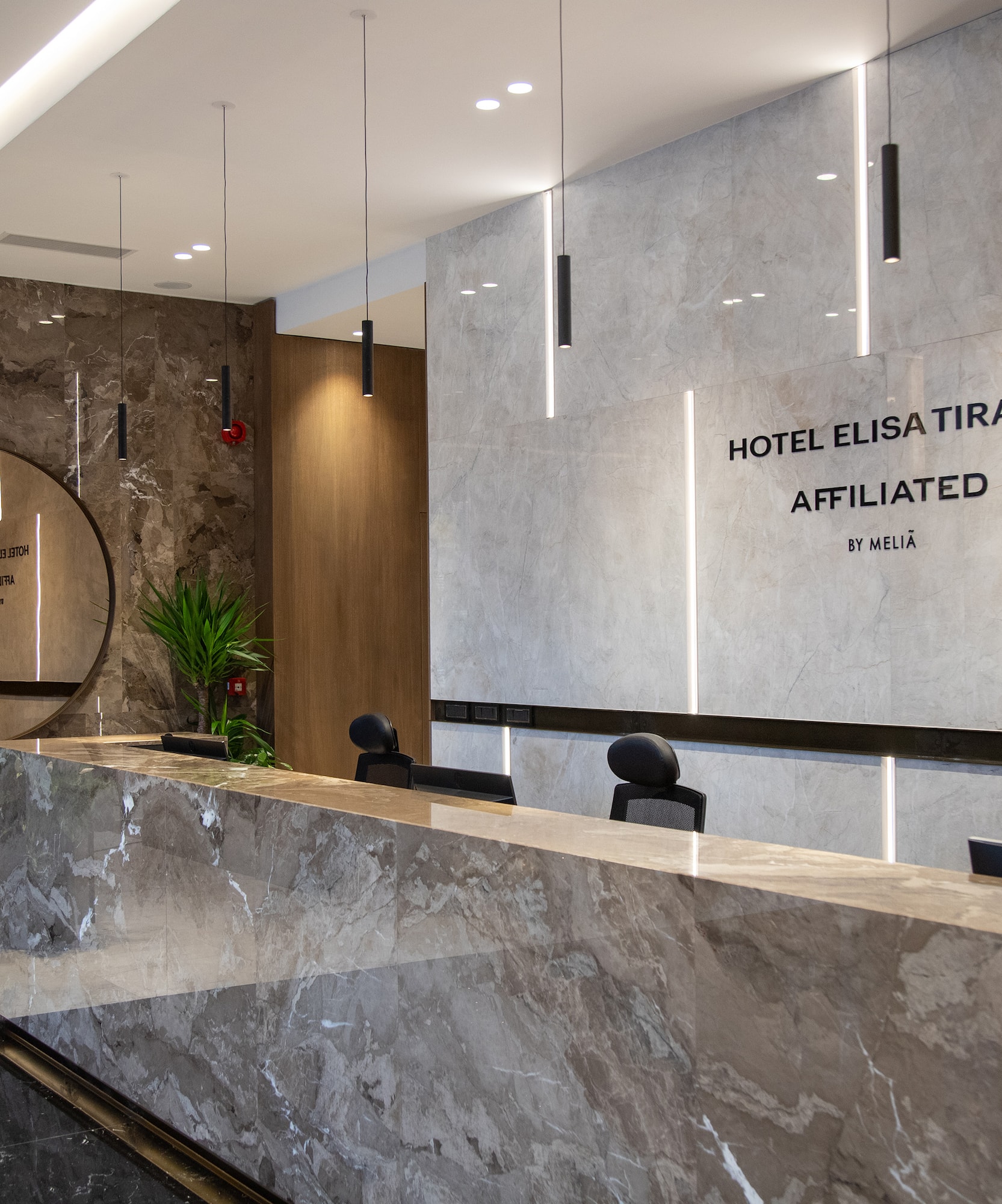 a marble reception desk in a hotel