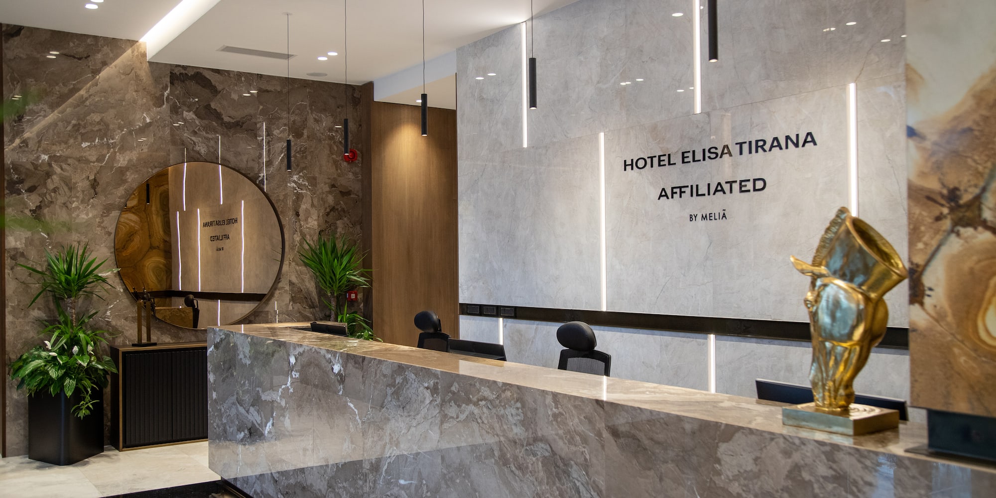 a marble reception desk in a hotel