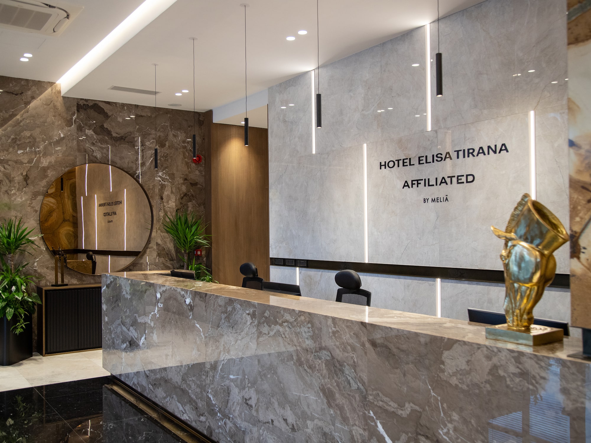 a marble reception desk in a hotel