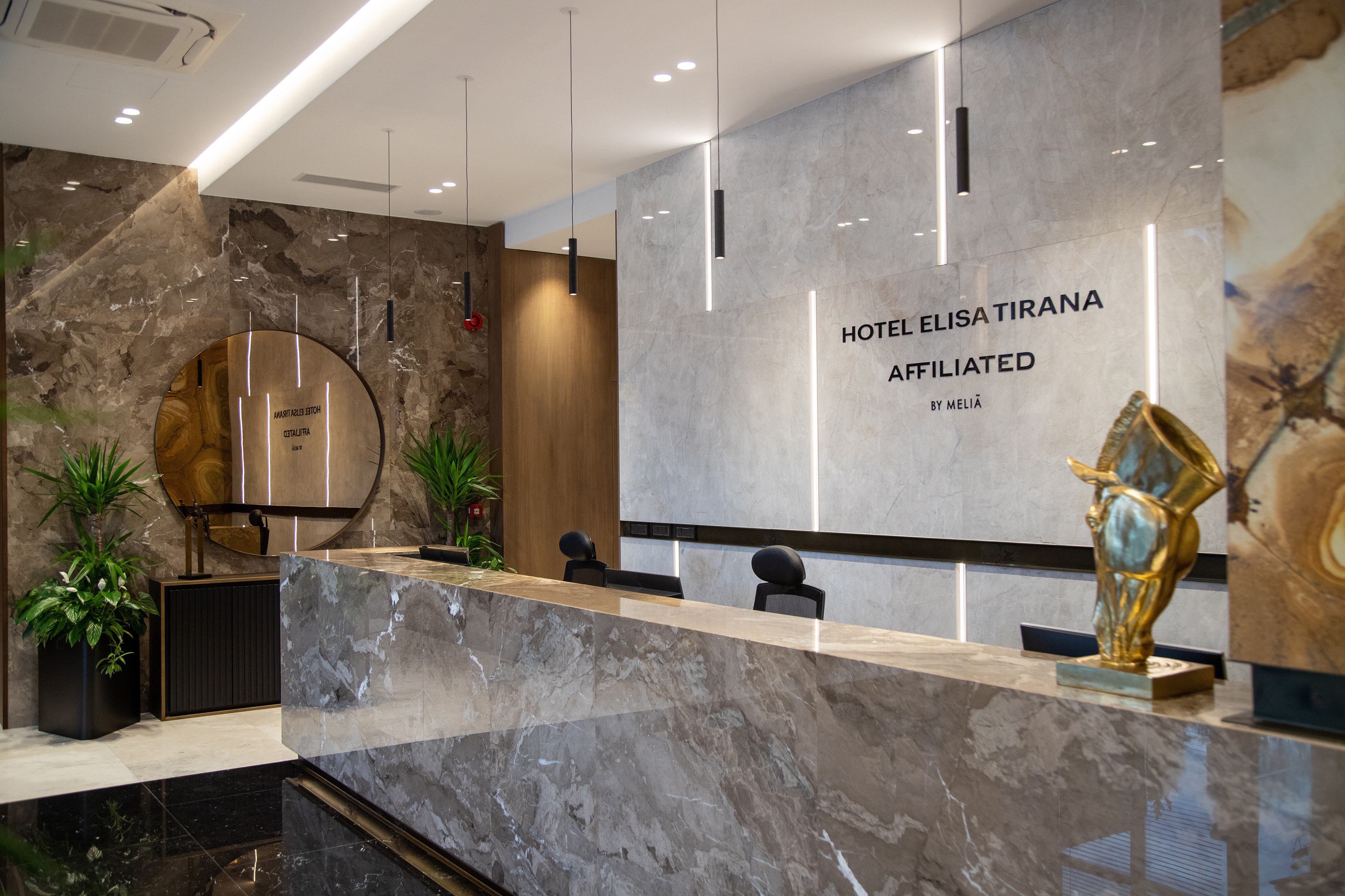 a marble reception desk in a hotel