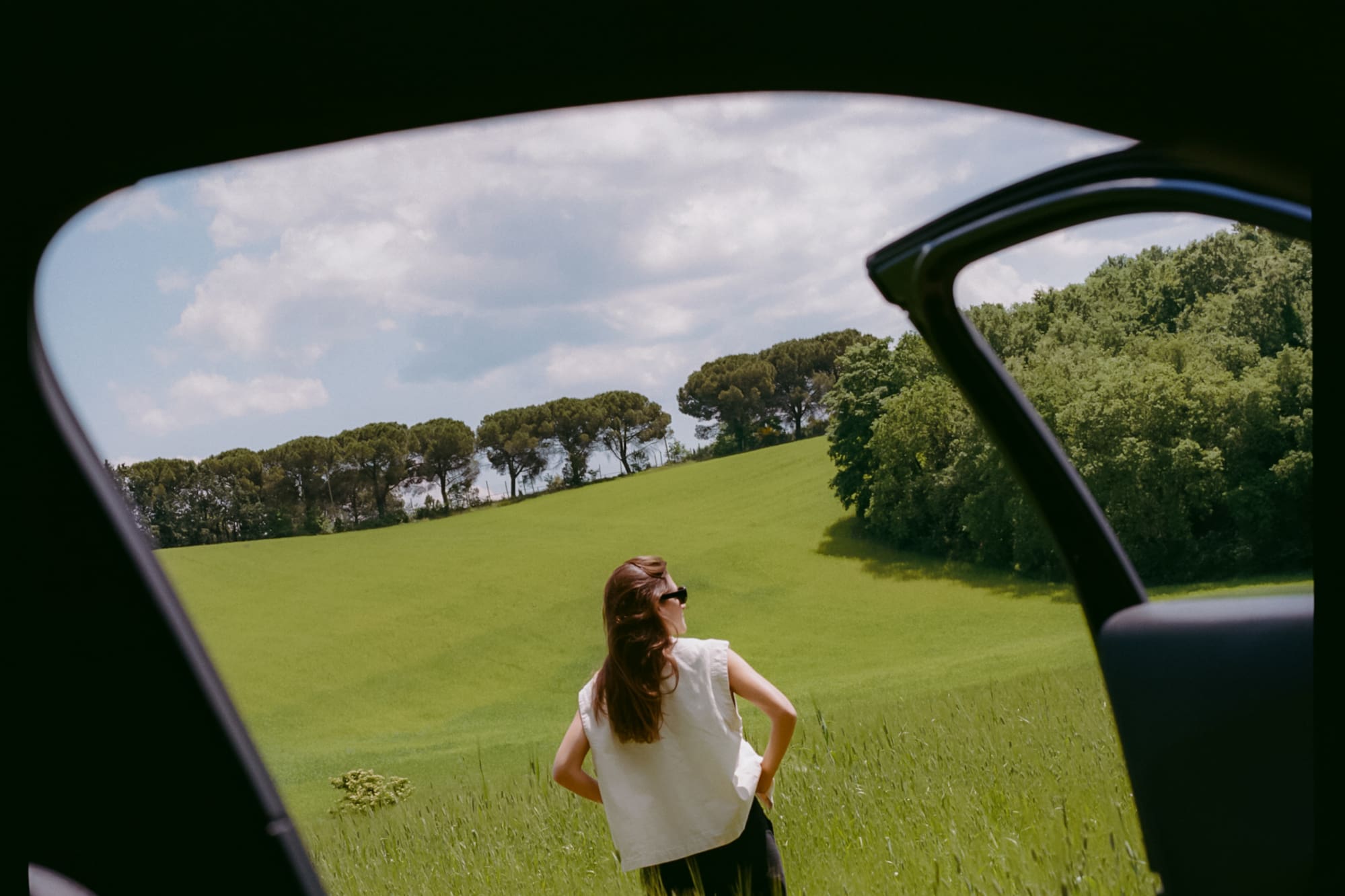 a woman standing in a field of grass