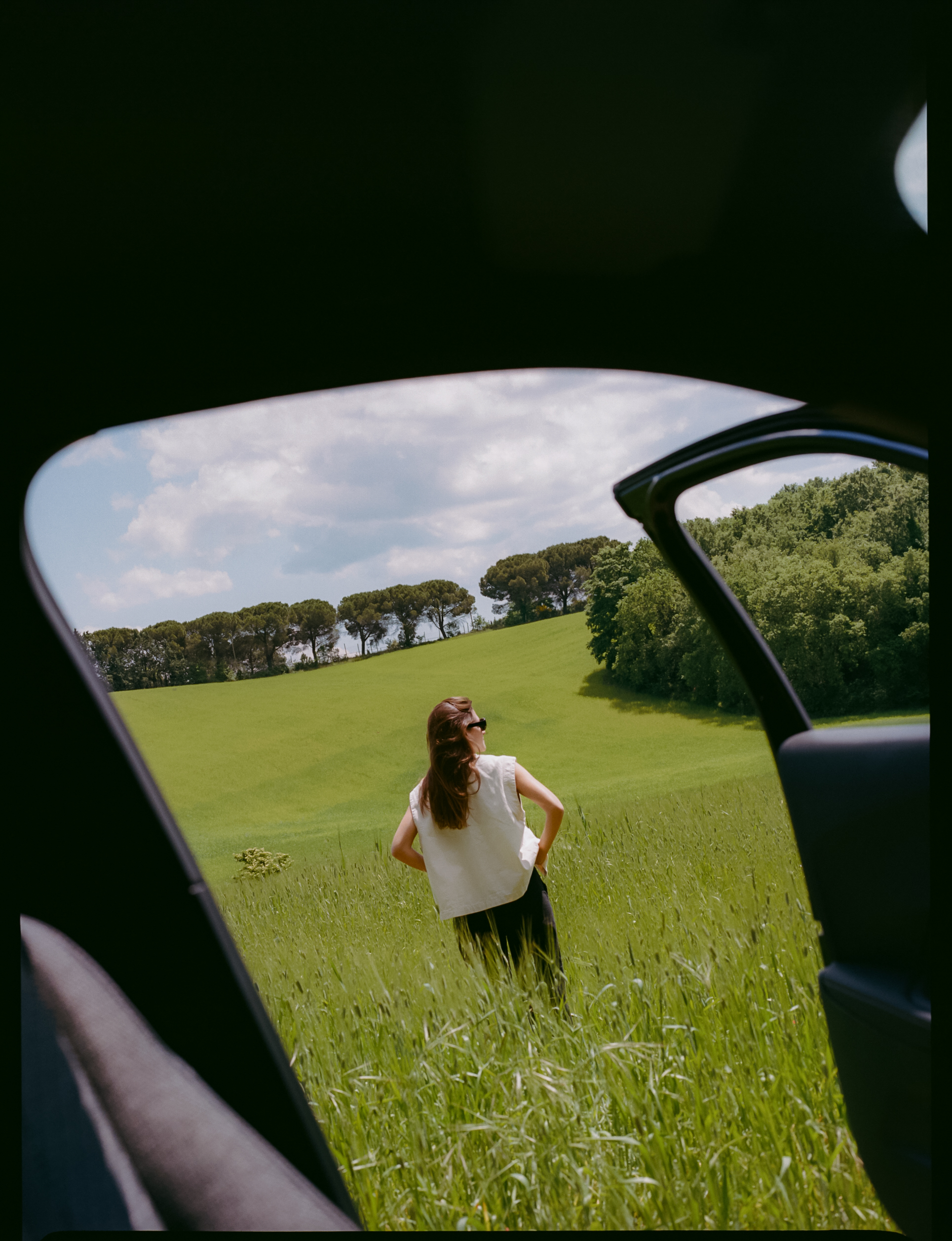 a woman standing in a field of grass