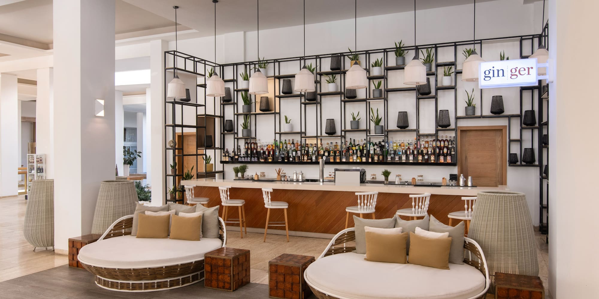 a lounge area with chairs and a bar