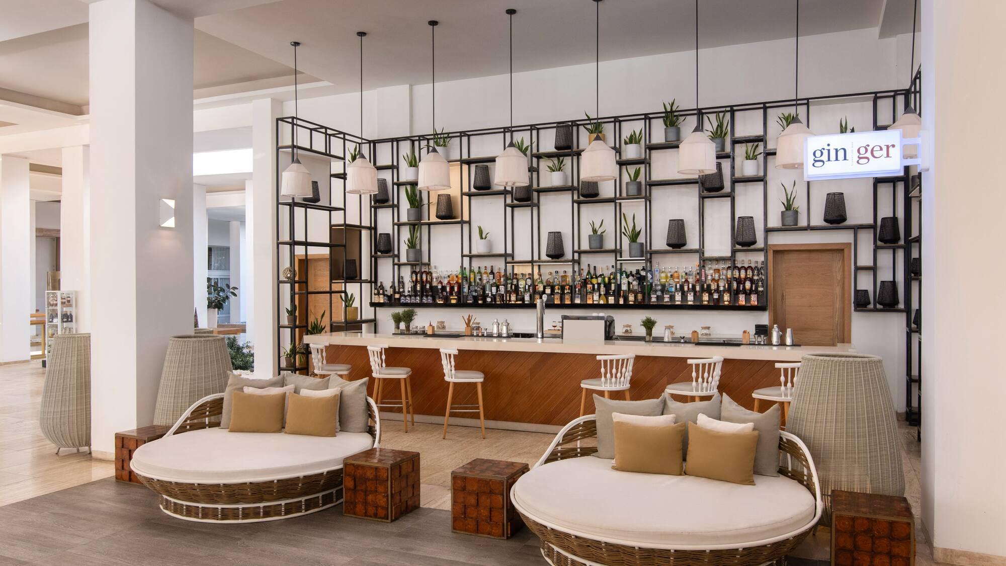 a lounge area with chairs and a bar