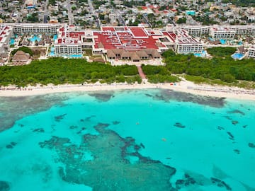 a beach with a building and trees
