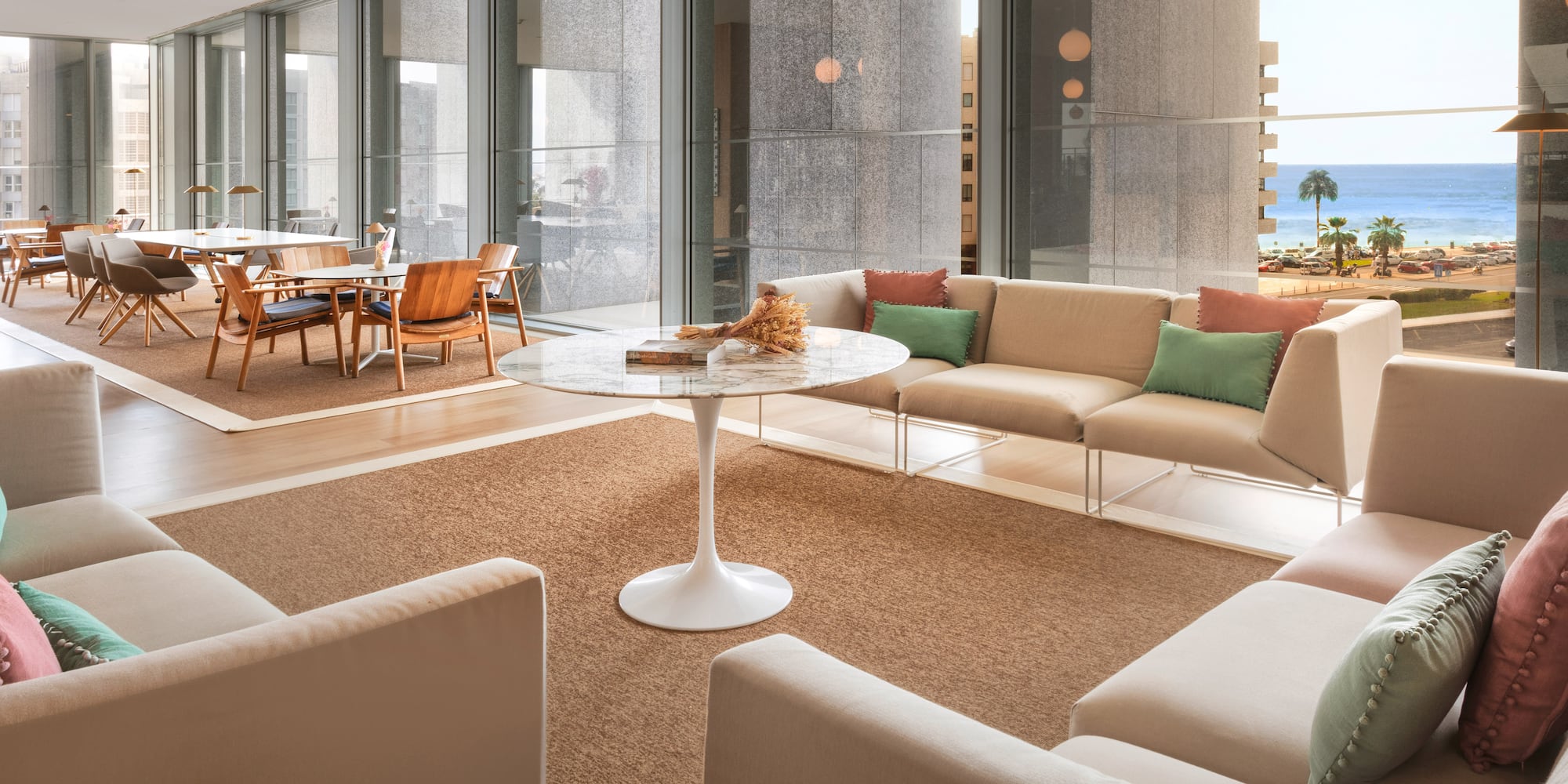 a room with a glass wall and a table and chairs