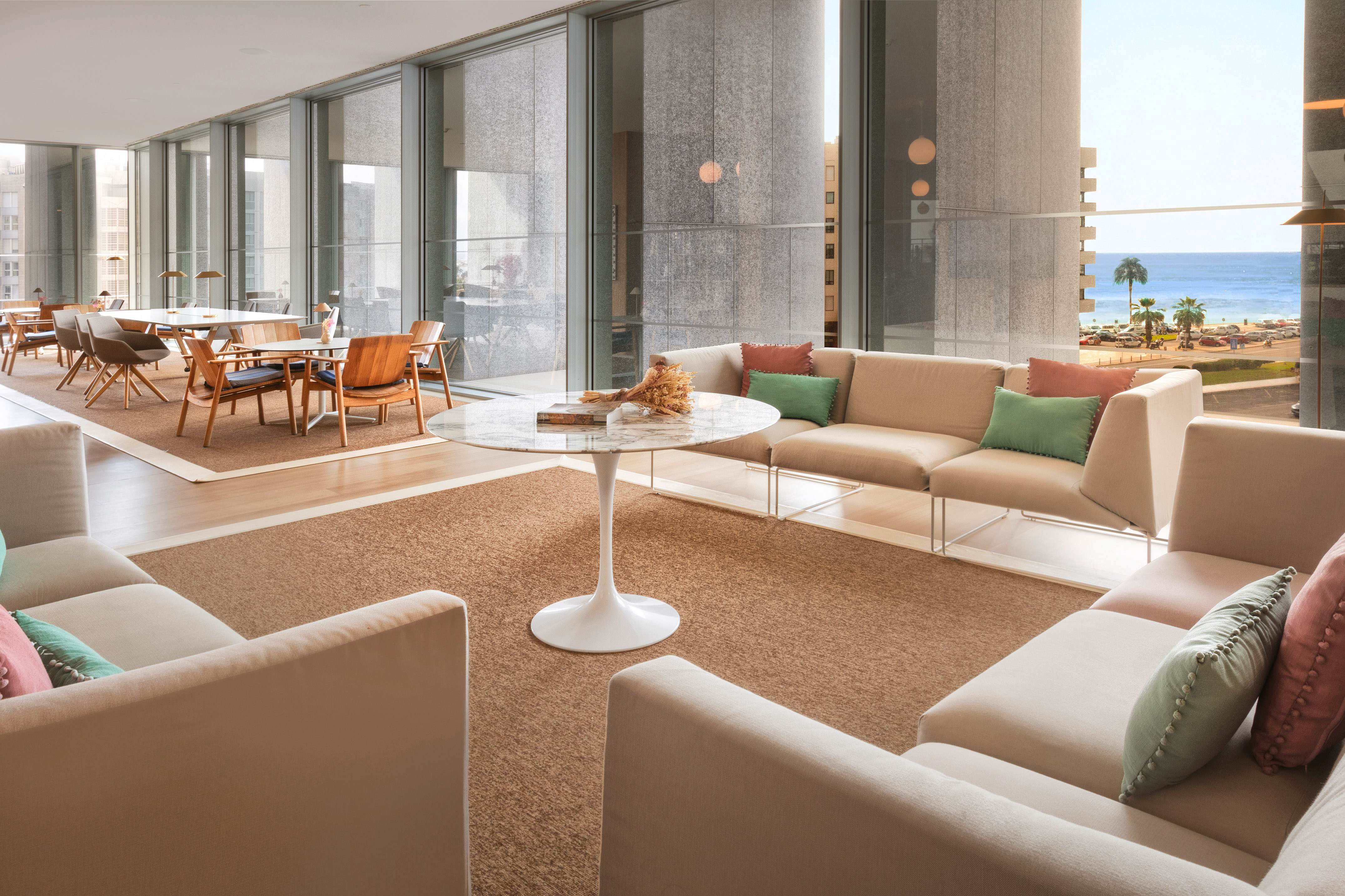 a room with a glass wall and a table and chairs