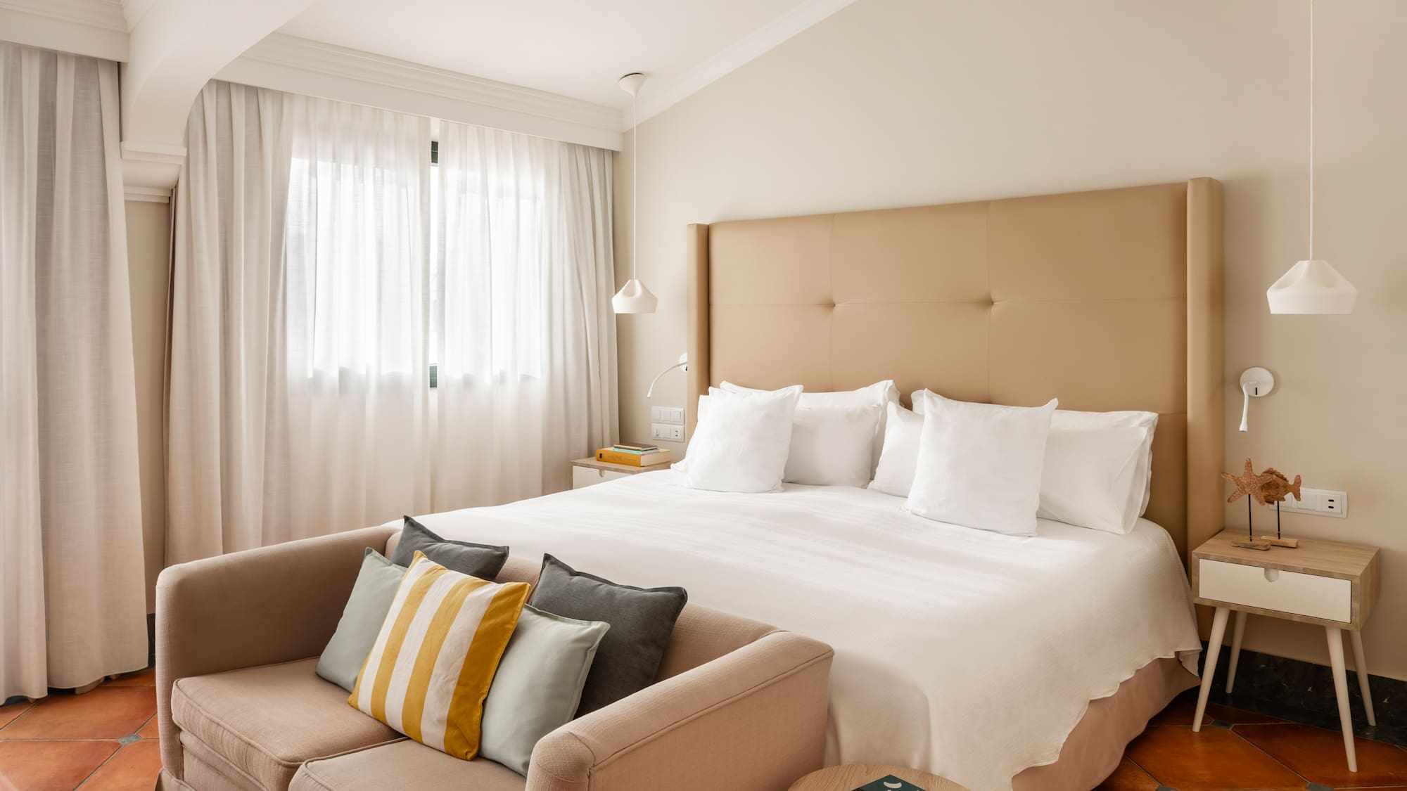 a bed with pillows and a couch in a room