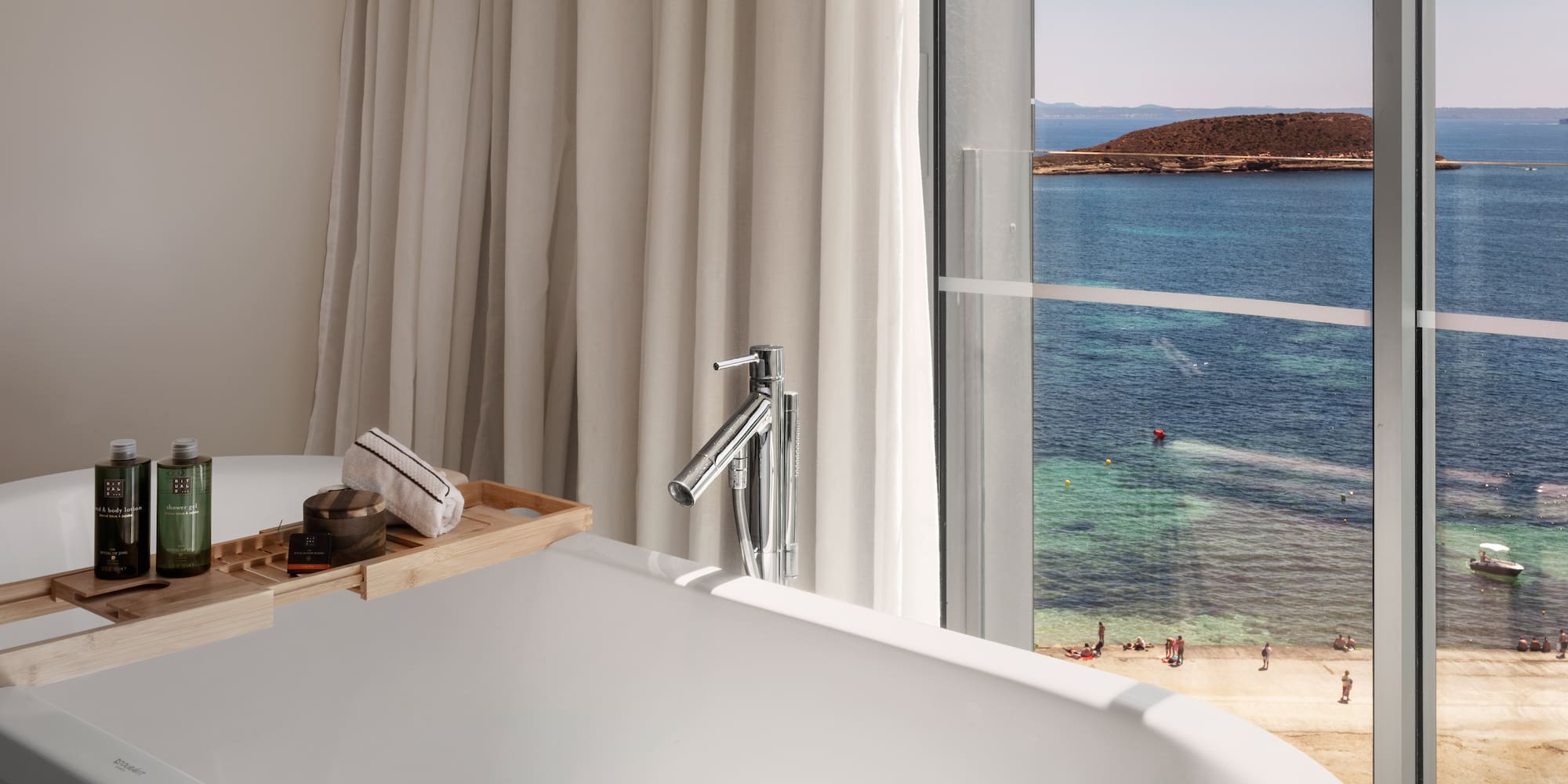 a bathtub with a view of the ocean