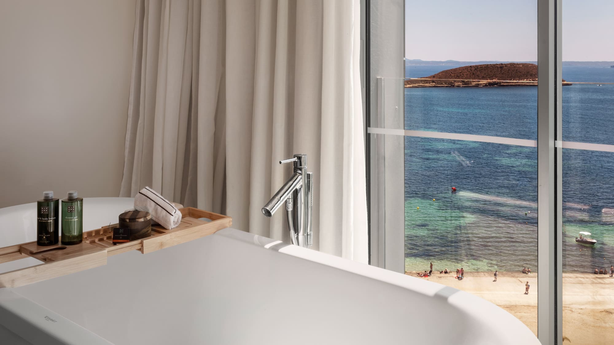 a bathtub with a view of the ocean