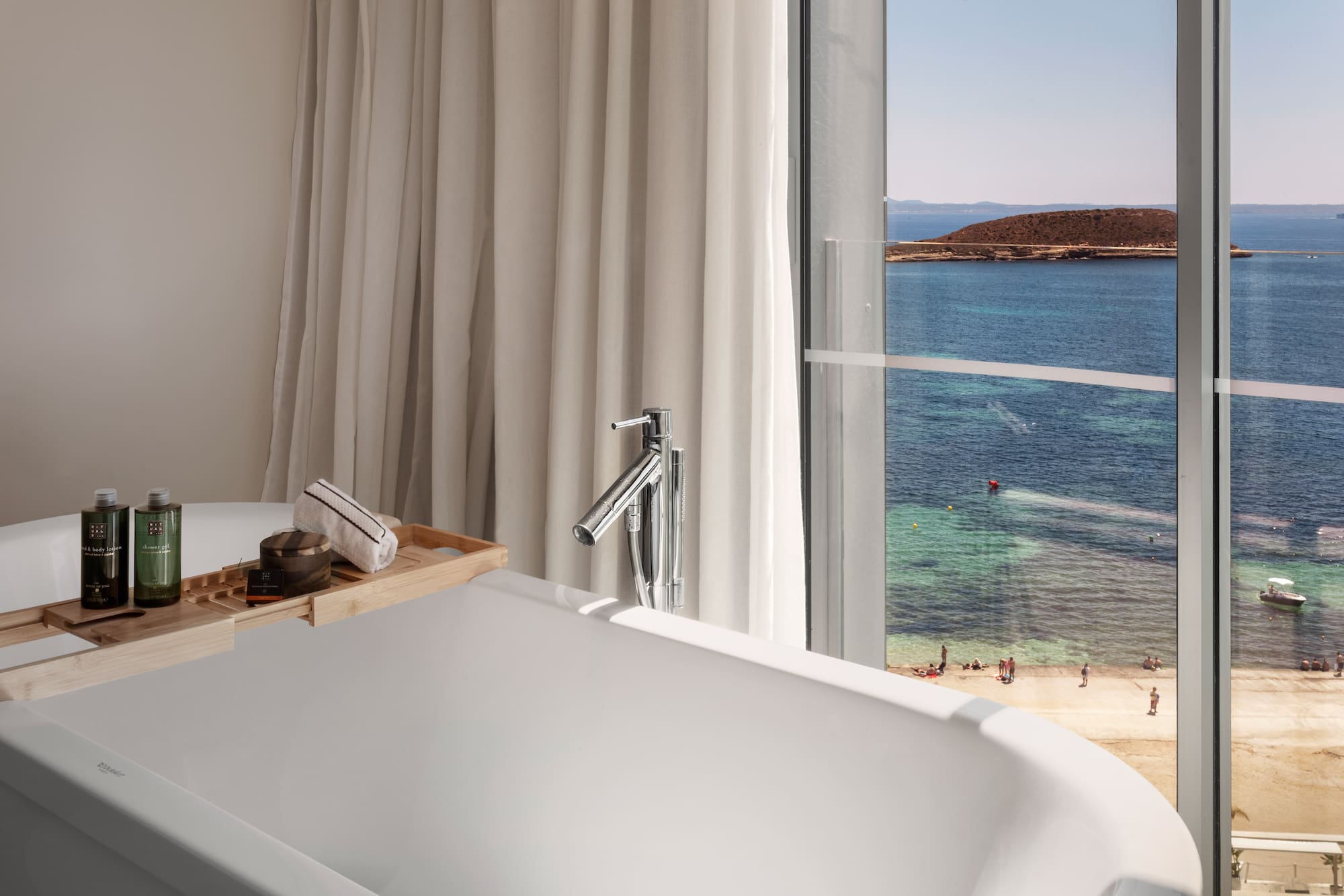 a bathtub with a view of the ocean