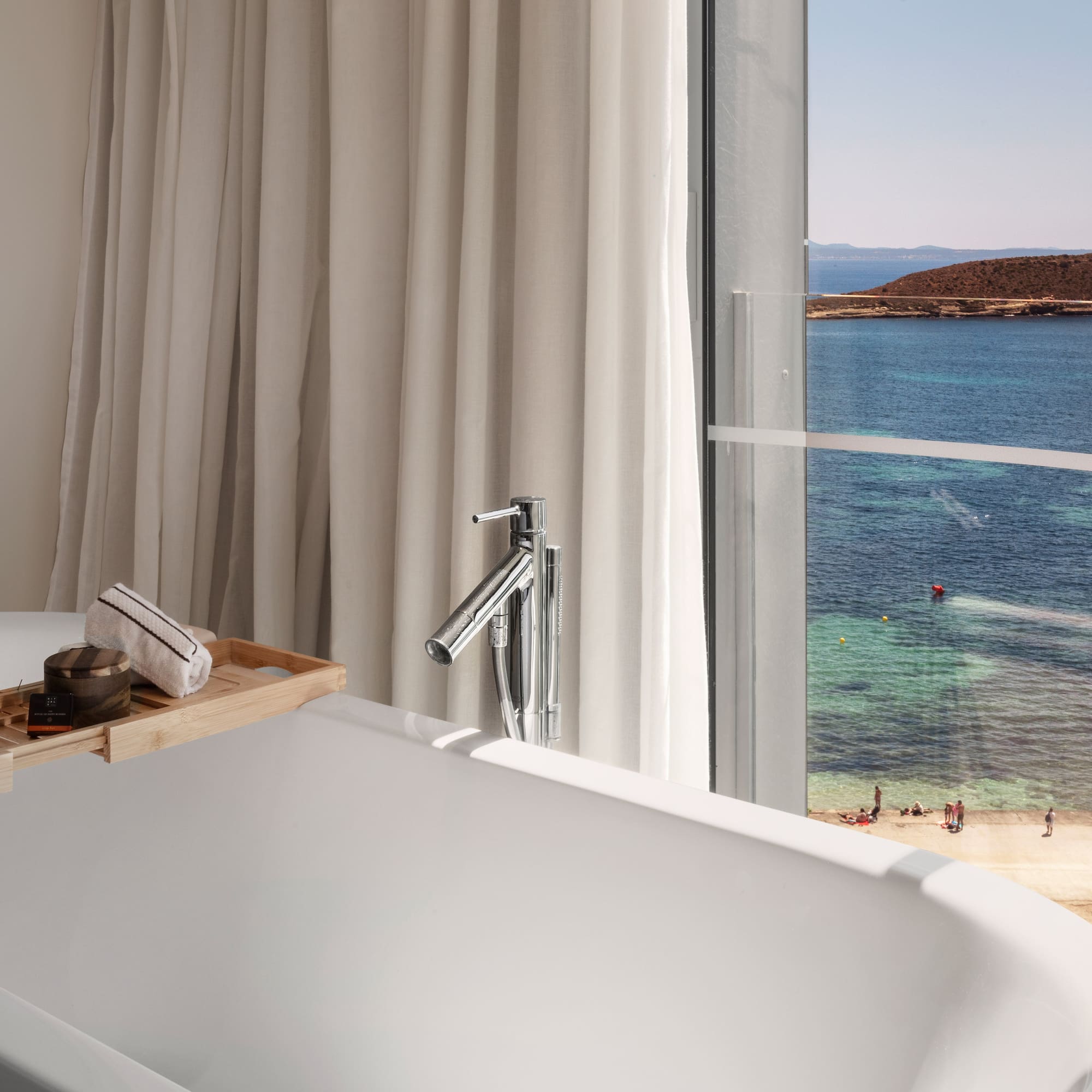 a bathtub with a view of the ocean