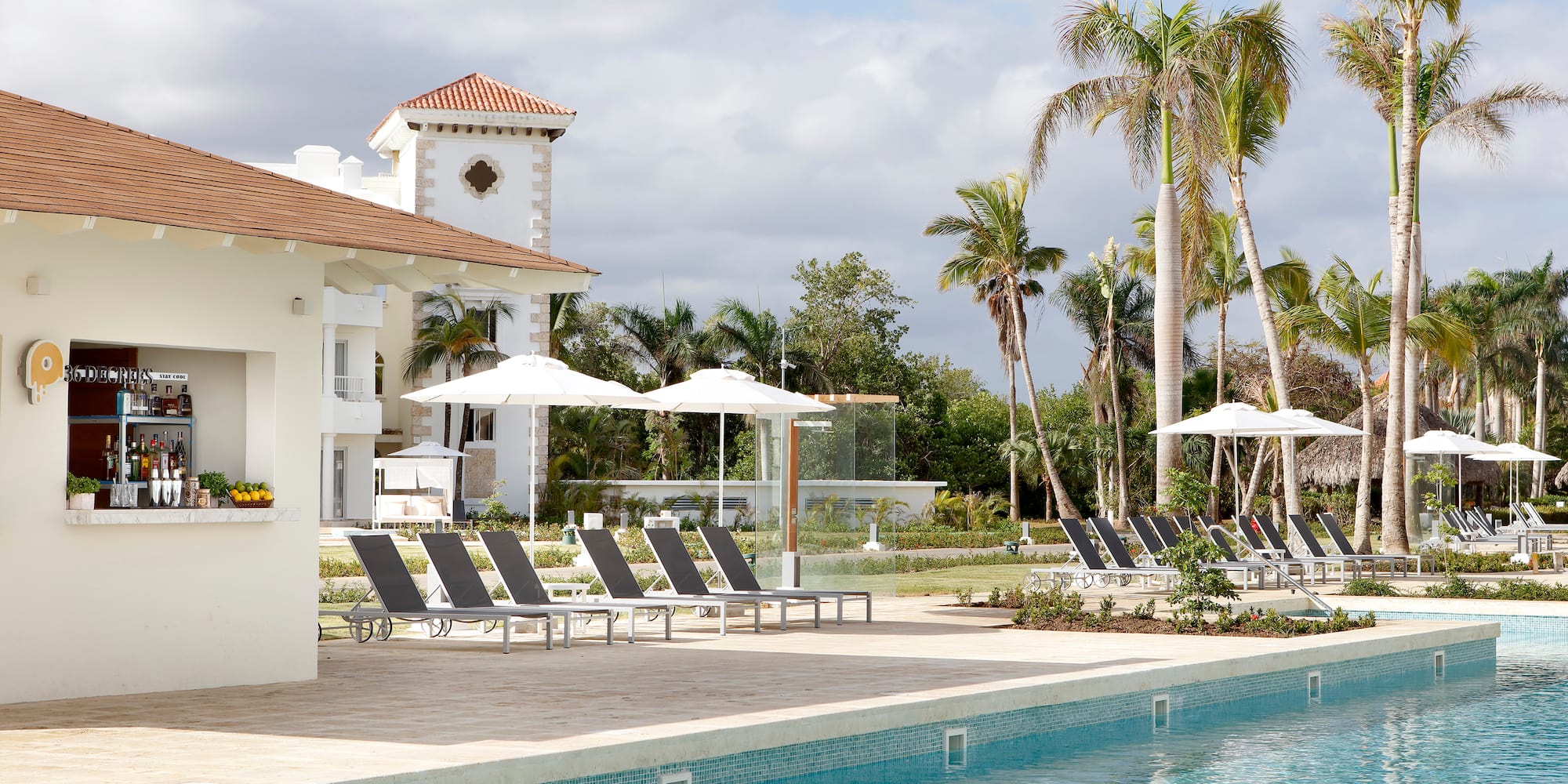 a pool with lounge chairs and umbrellas