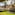 Historic villa garden with fountain, outdoor event setup, and flowering arch.