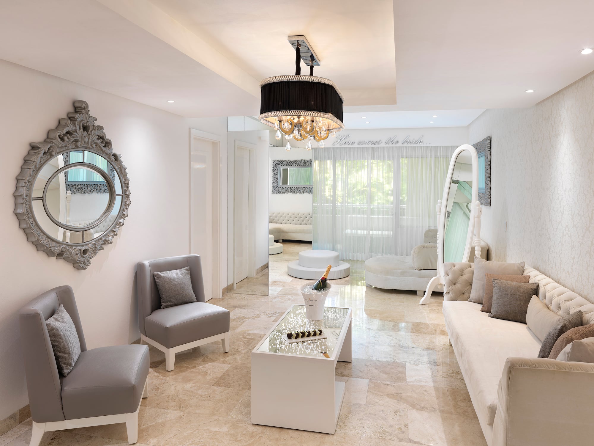 a room with a chandelier and couches