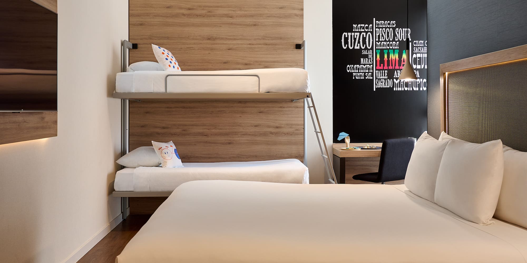 a room with bunk beds and a desk