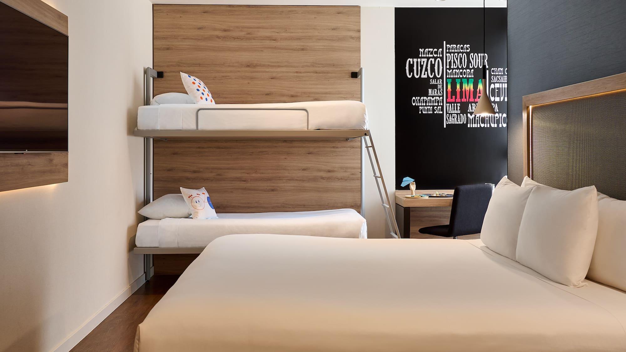 a room with bunk beds and a desk