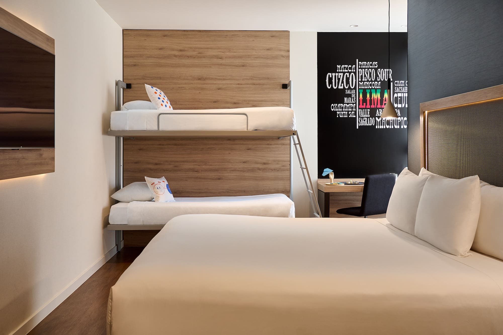 a room with bunk beds and a desk