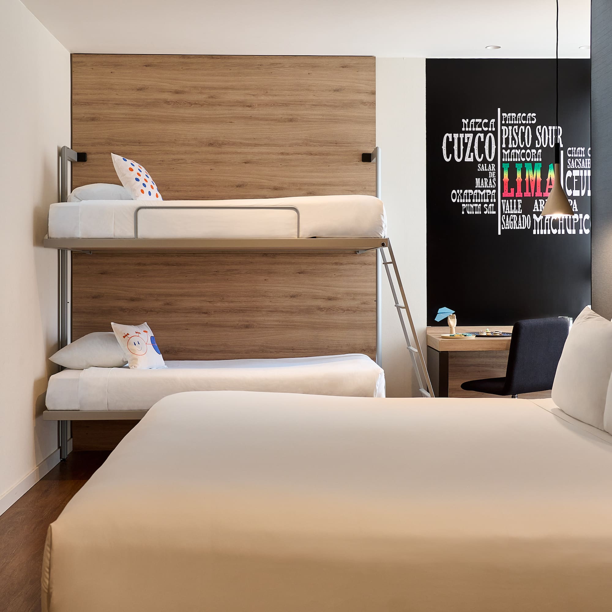 a room with bunk beds and a desk