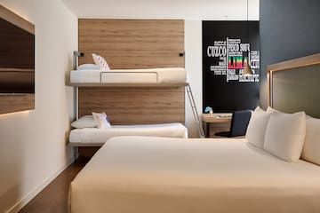 a room with bunk beds and a desk
