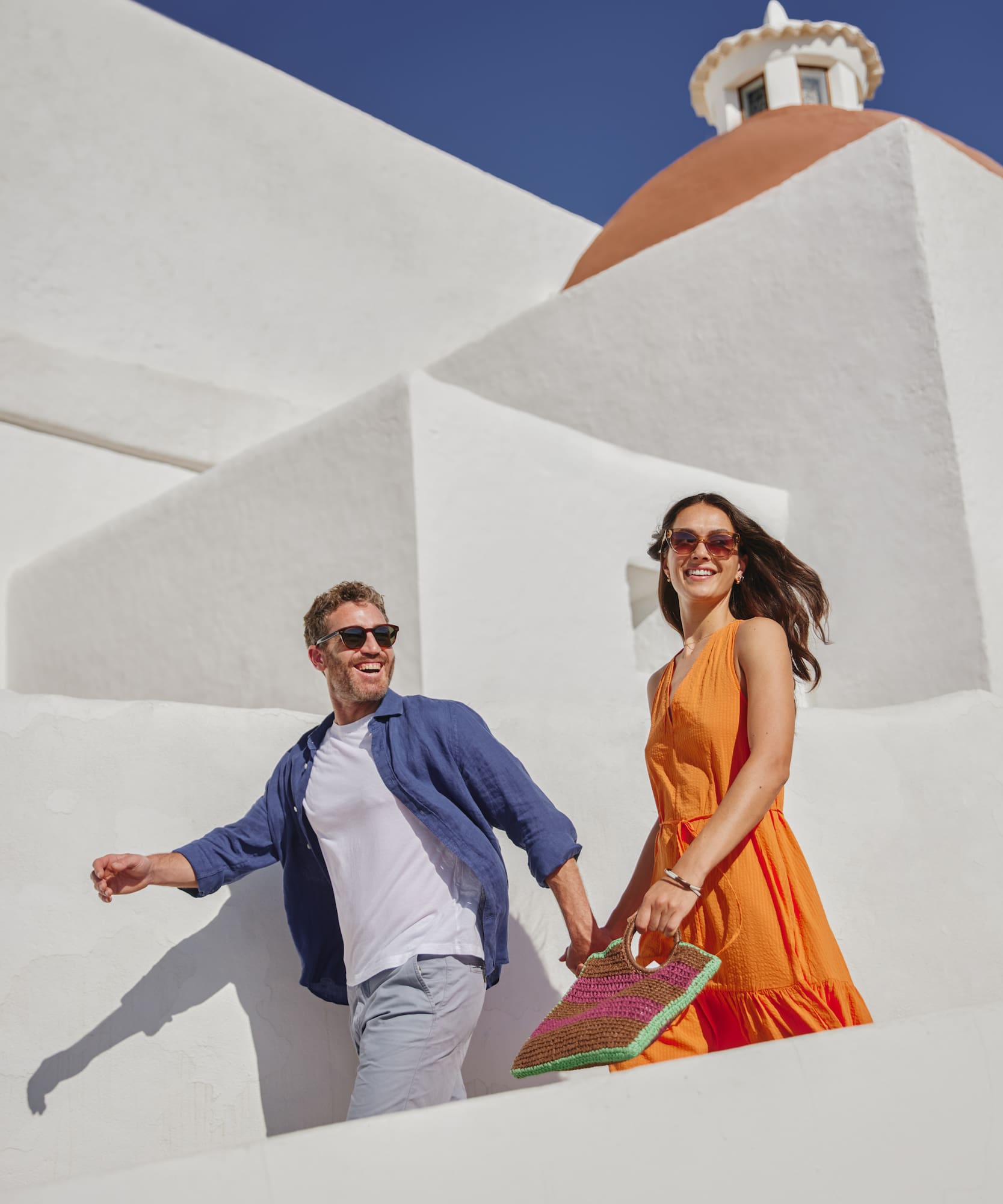 a man and woman walking down stairs