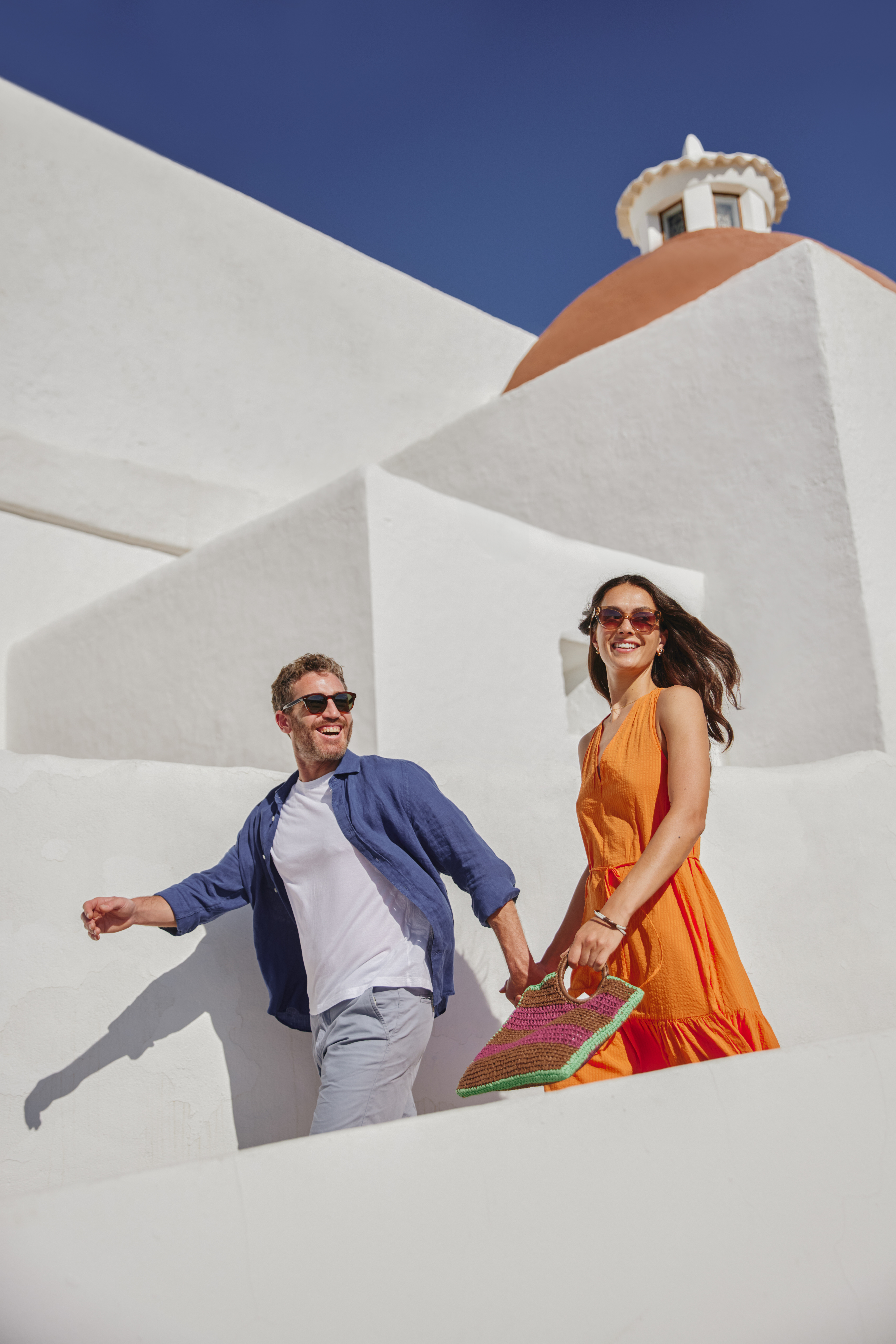 a man and woman walking down stairs