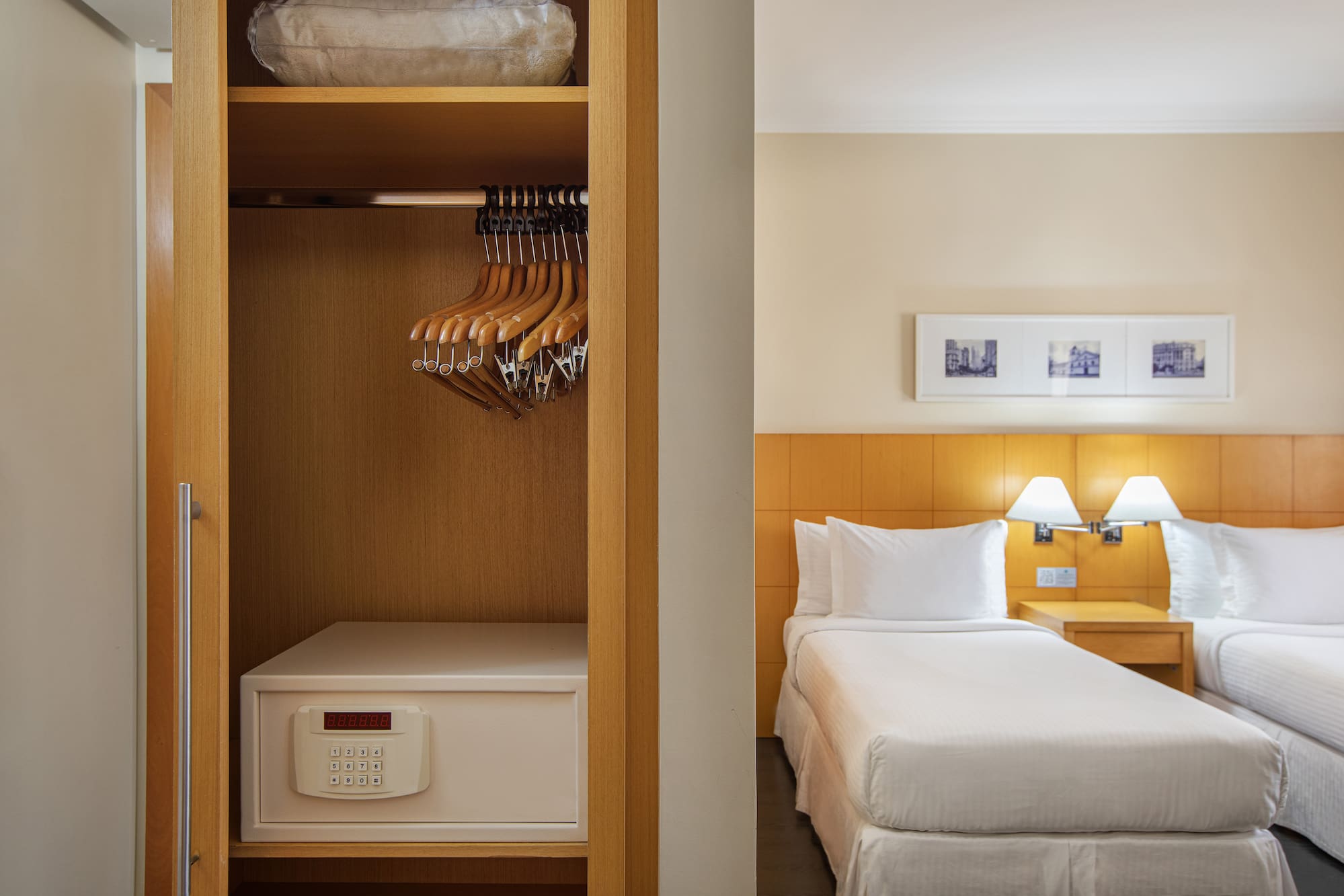 a closet with swingers and a bed in a hotel room