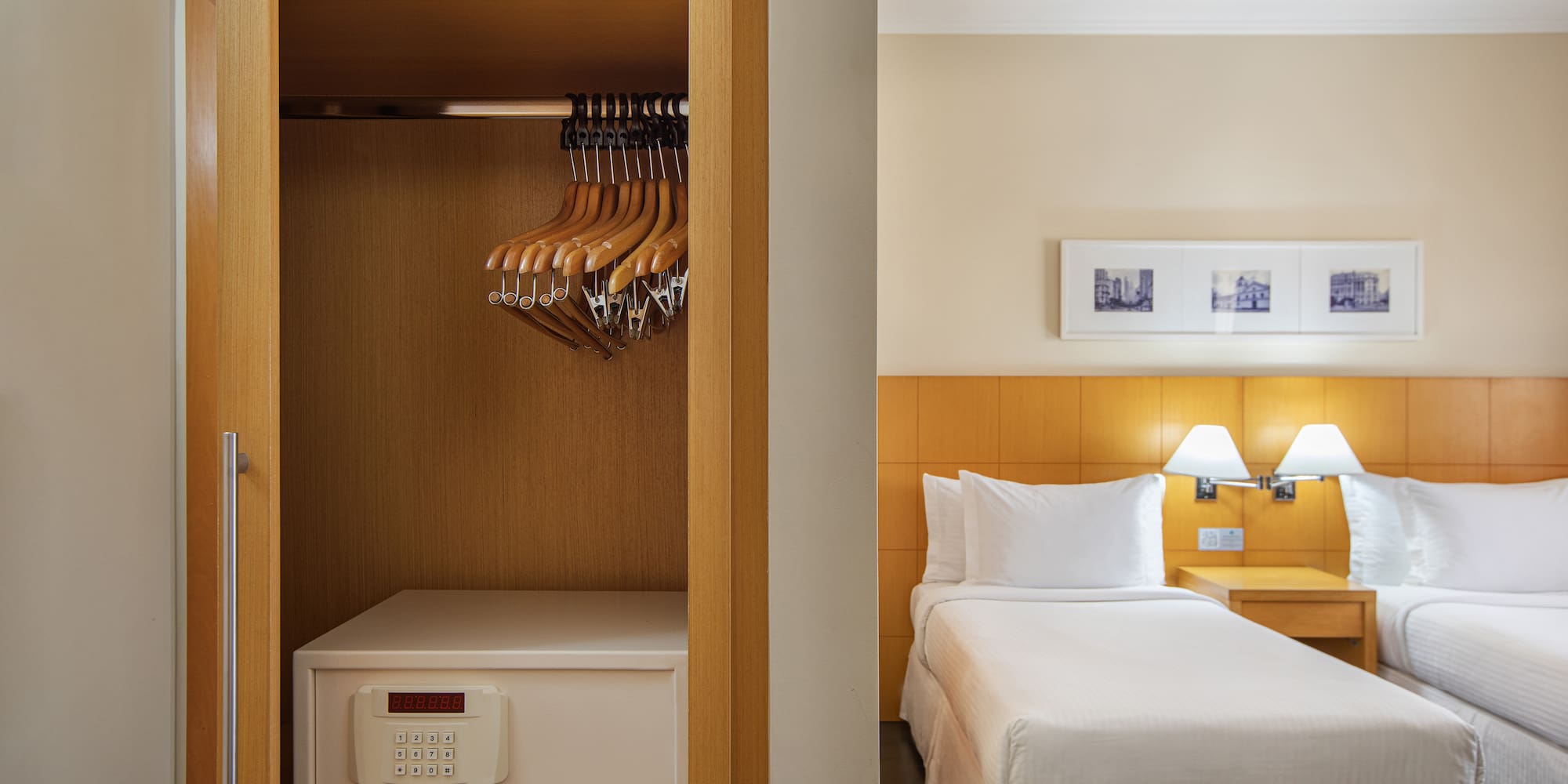 a closet with swingers and a bed in a hotel room
