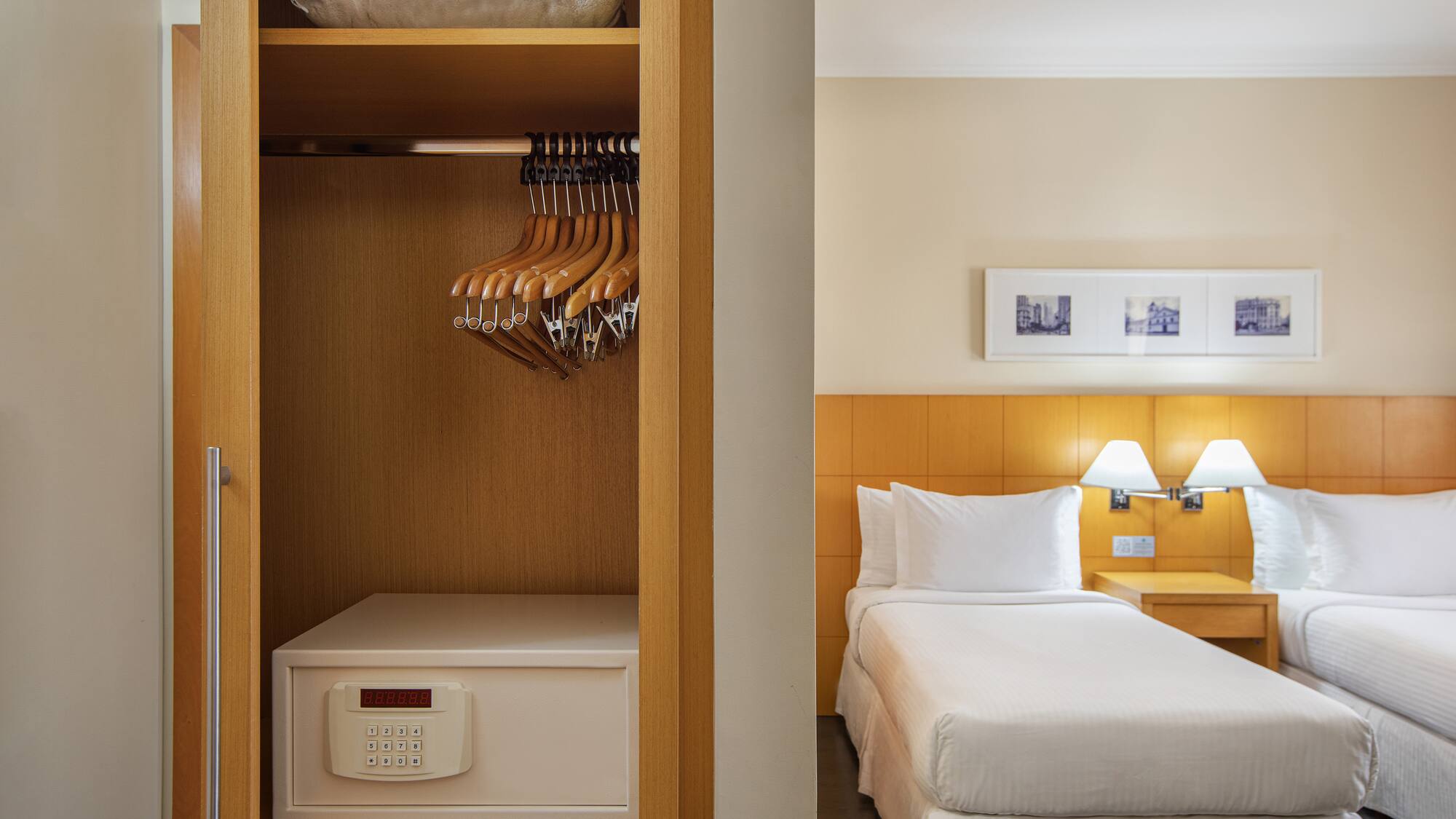 a closet with swingers and a bed in a hotel room