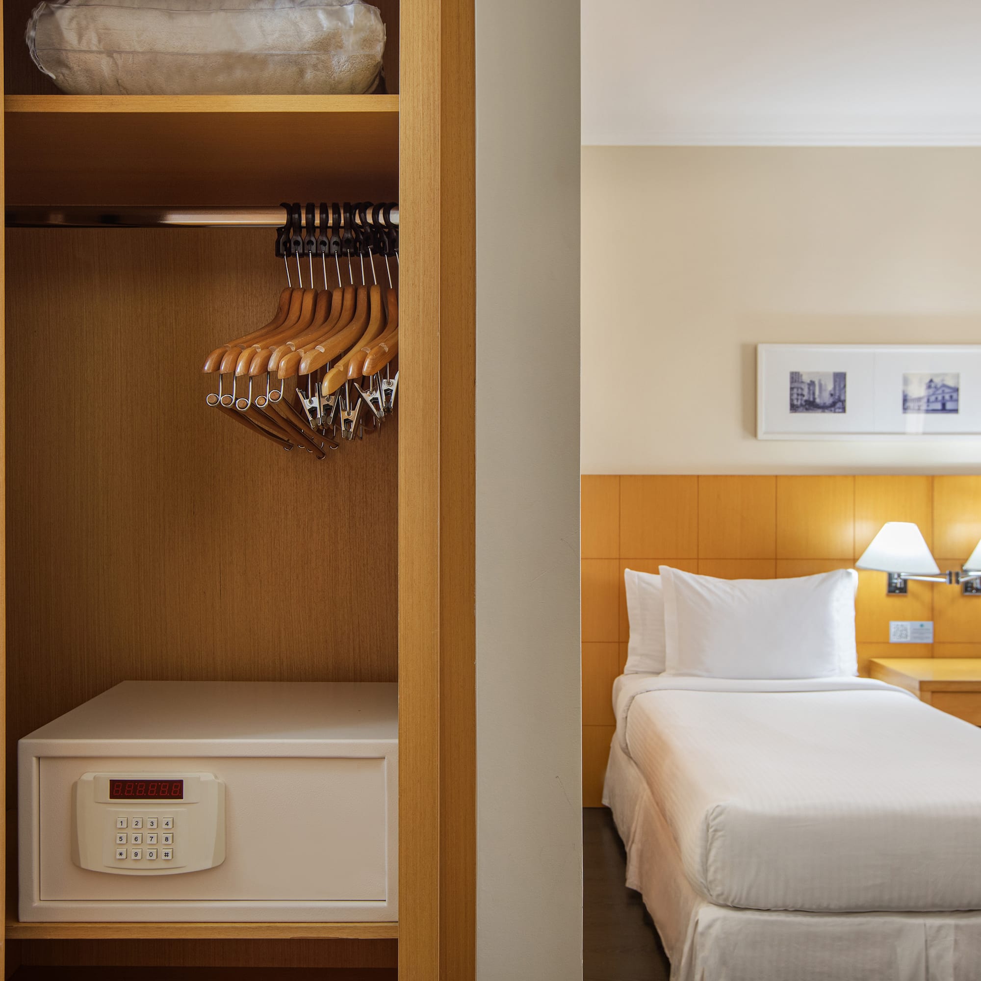 a closet with swingers and a bed in a hotel room