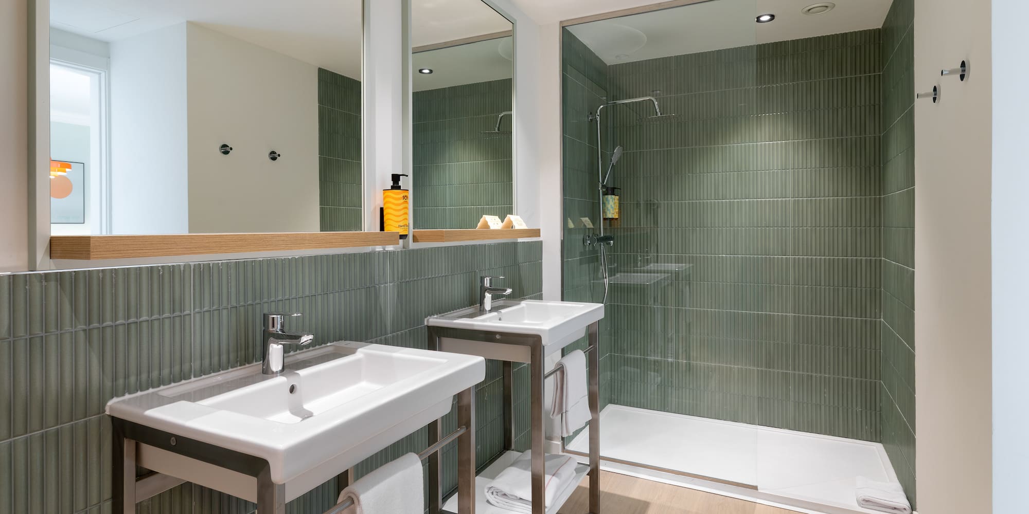 a bathroom with a shower and two sinks