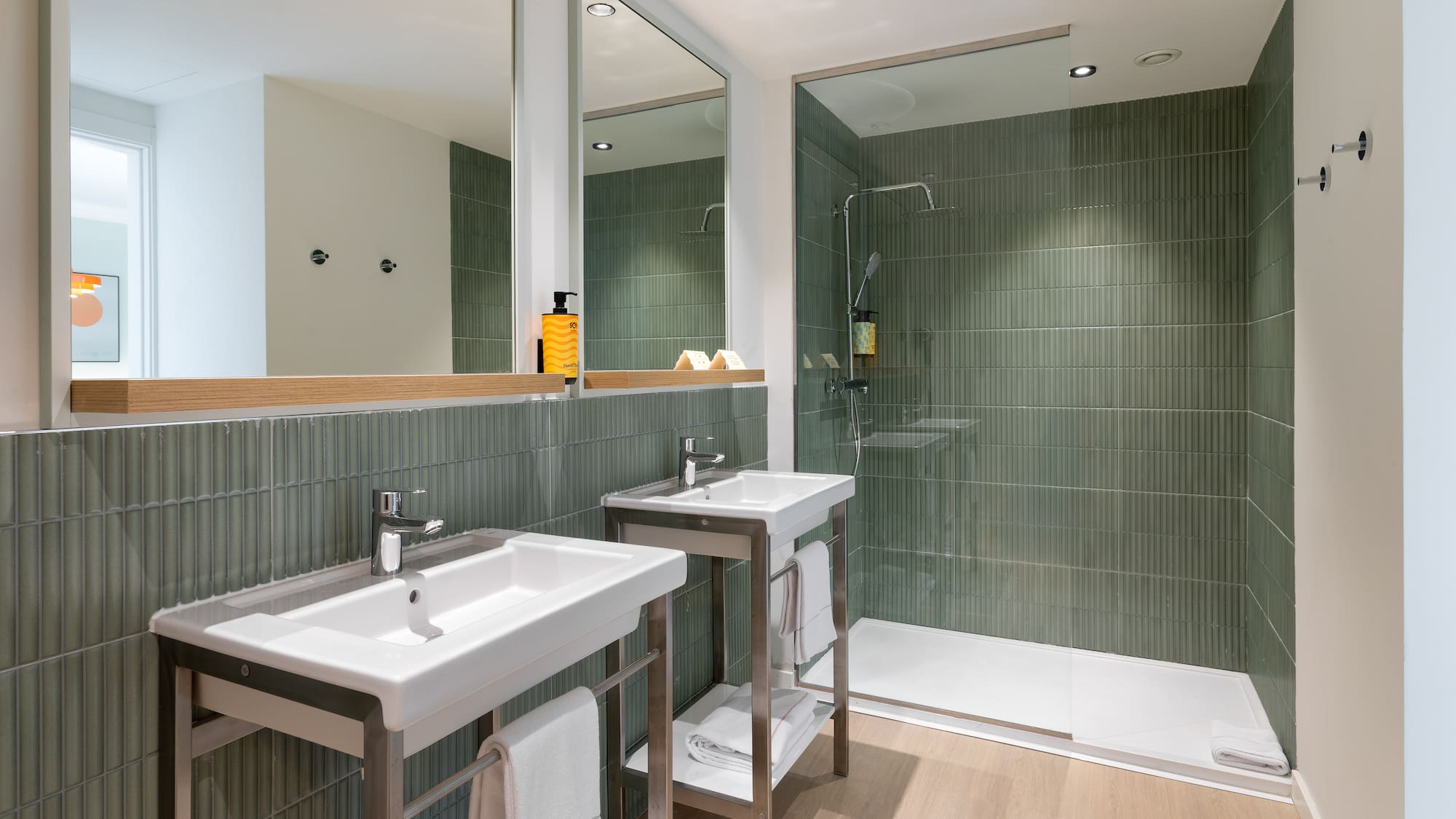 a bathroom with a shower and two sinks