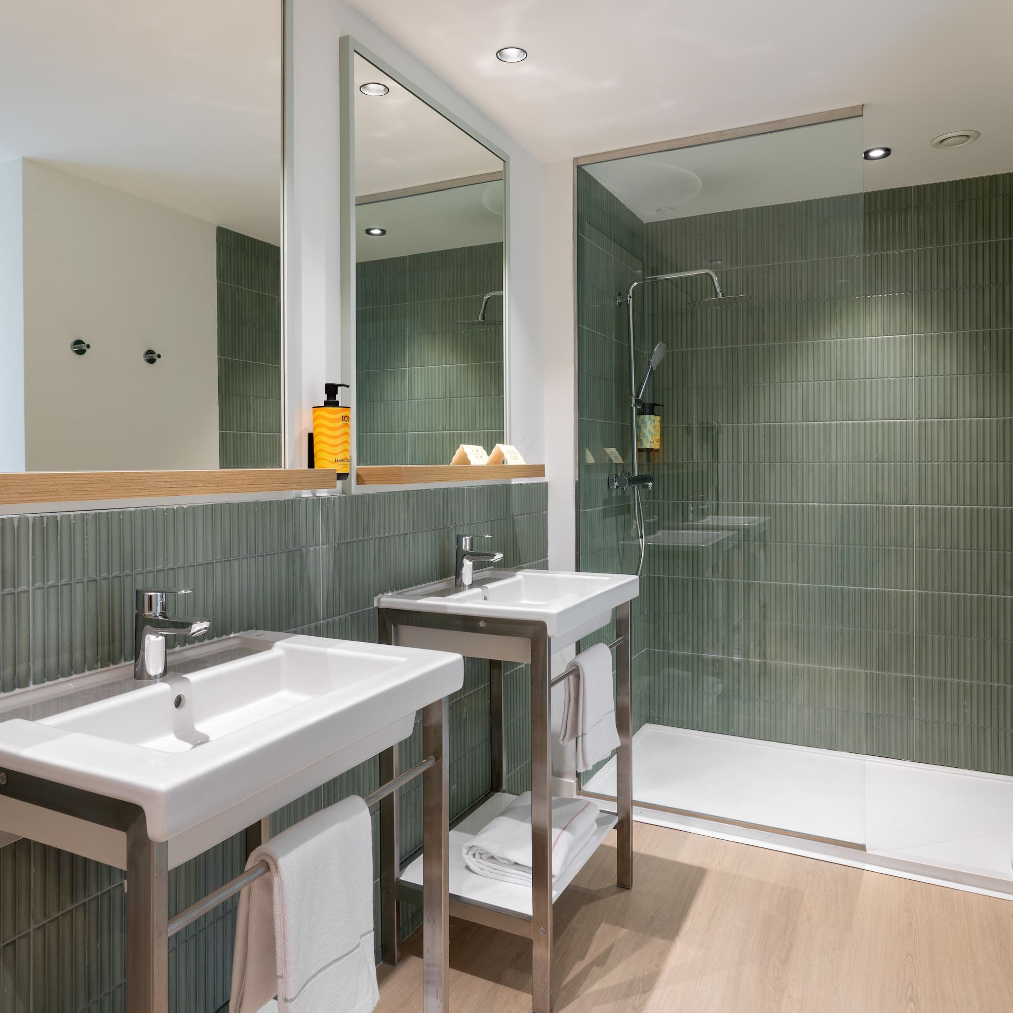 a bathroom with a shower and two sinks