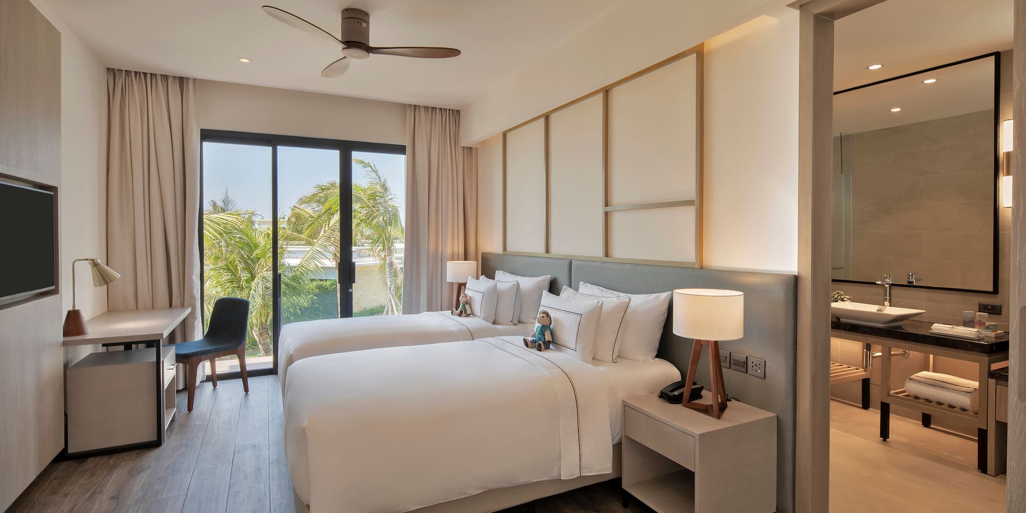 a room with two beds and a desk