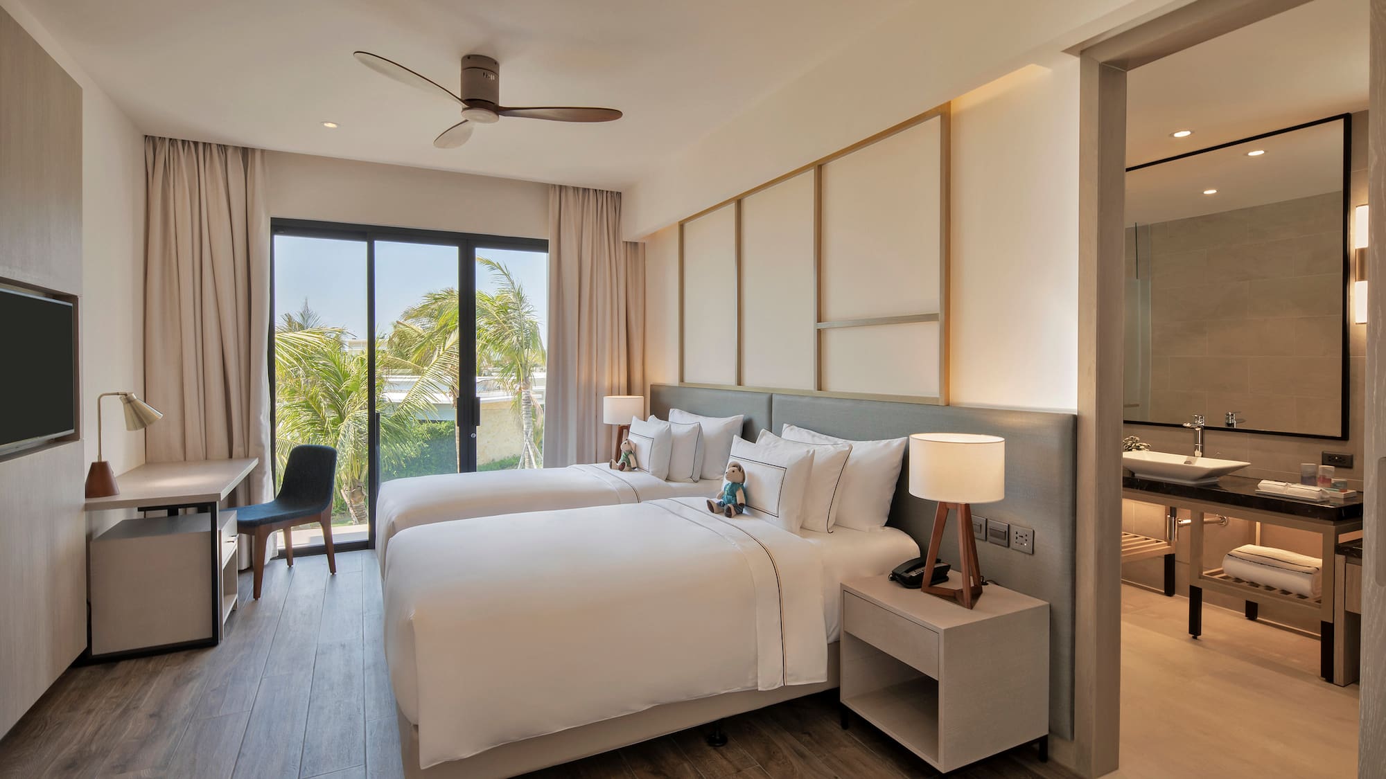 a room with two beds and a desk