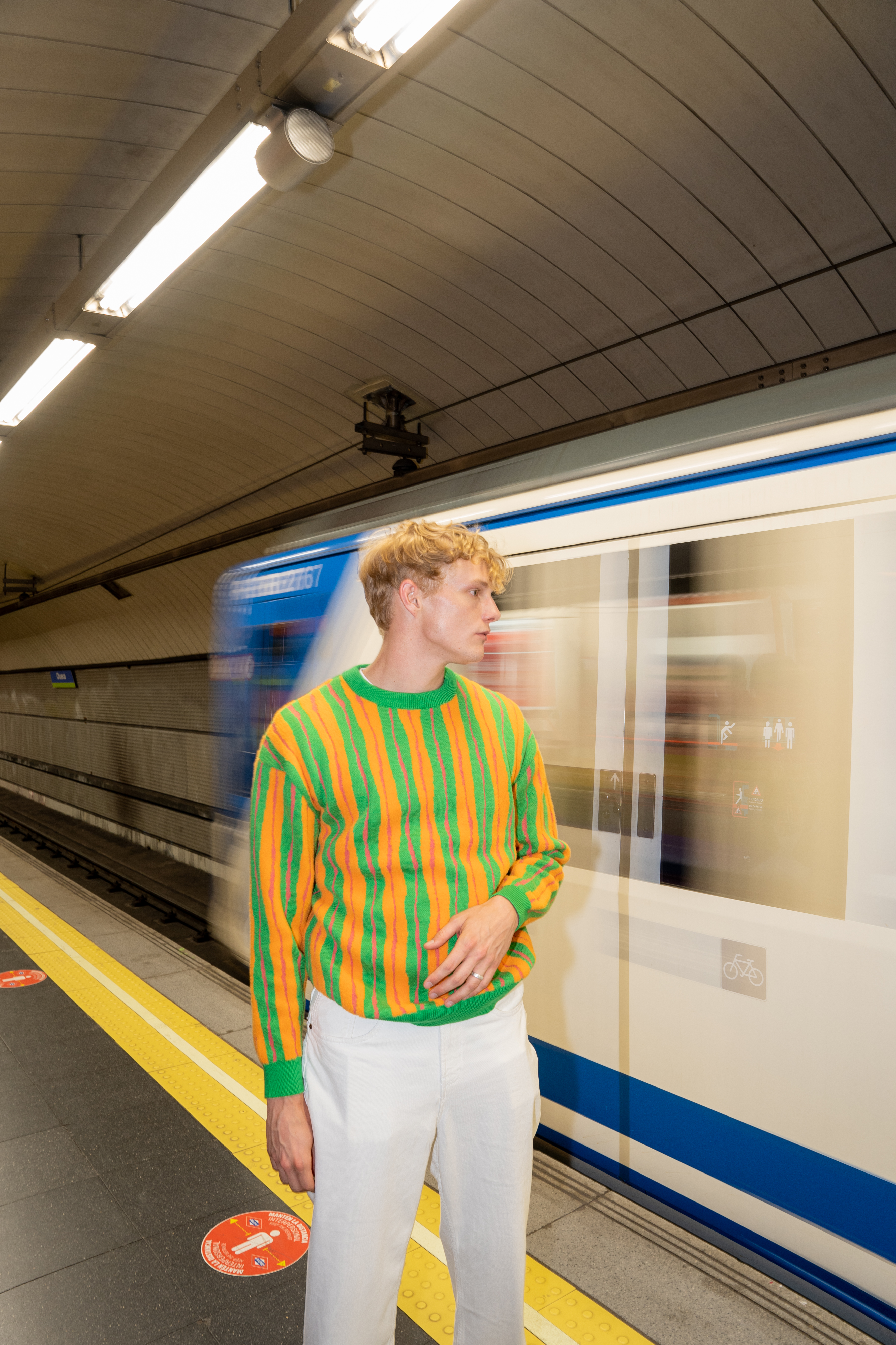 a man standing in a subway station