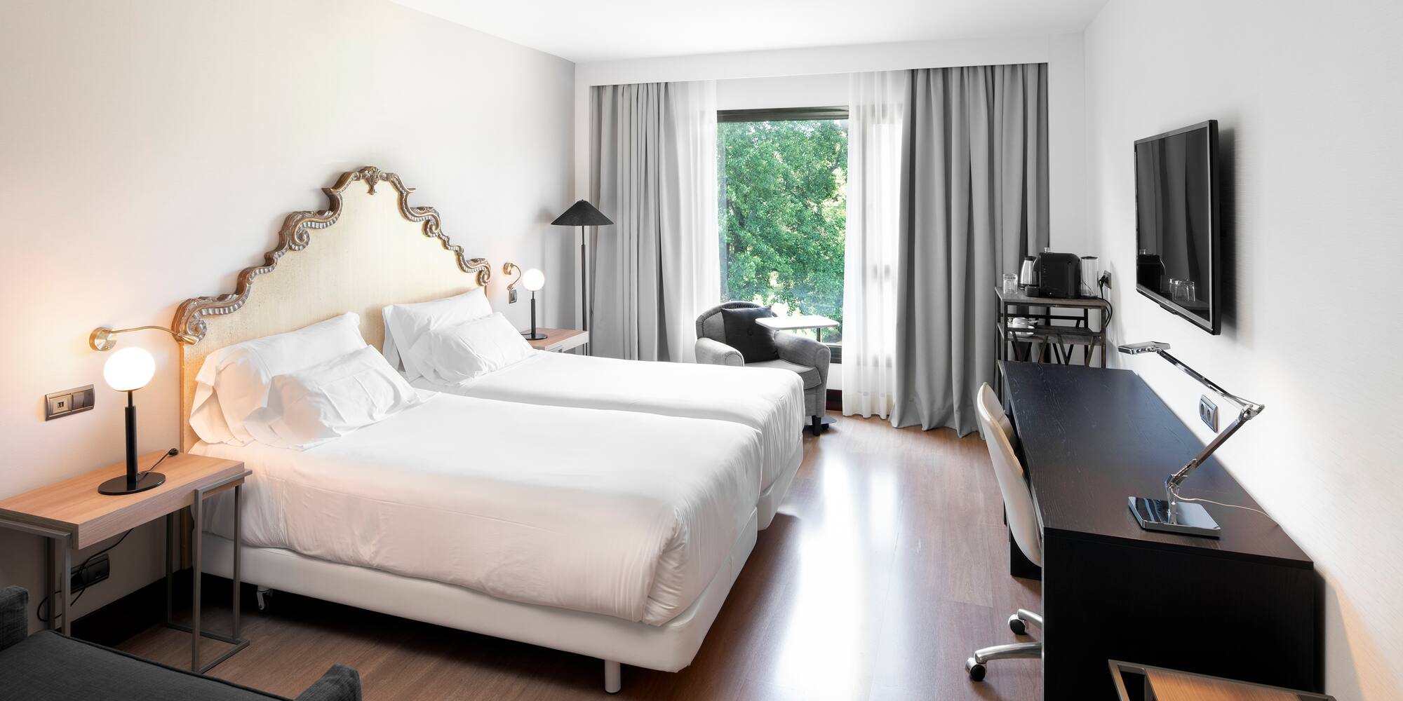 a room with two beds and a television