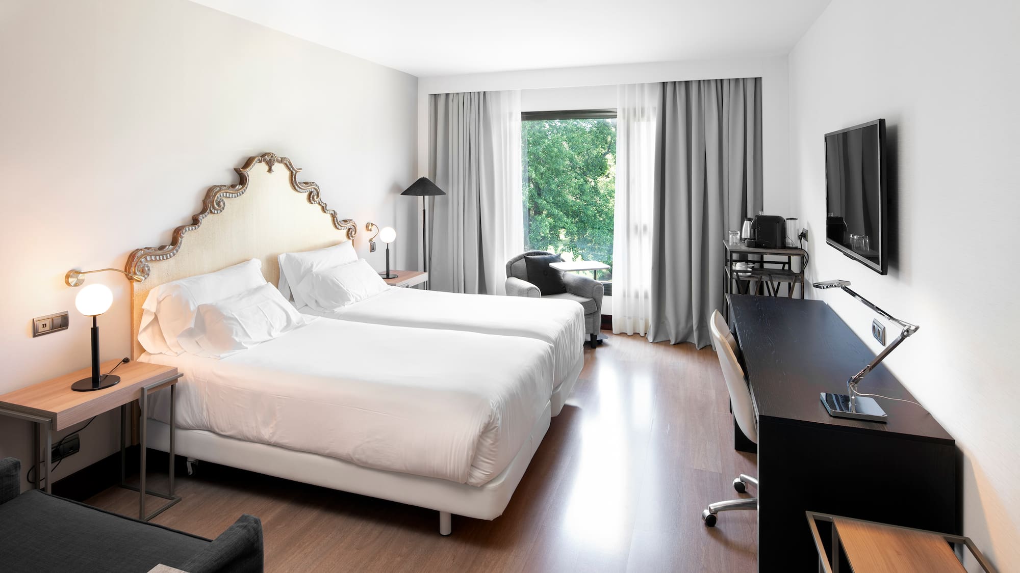 a room with two beds and a television