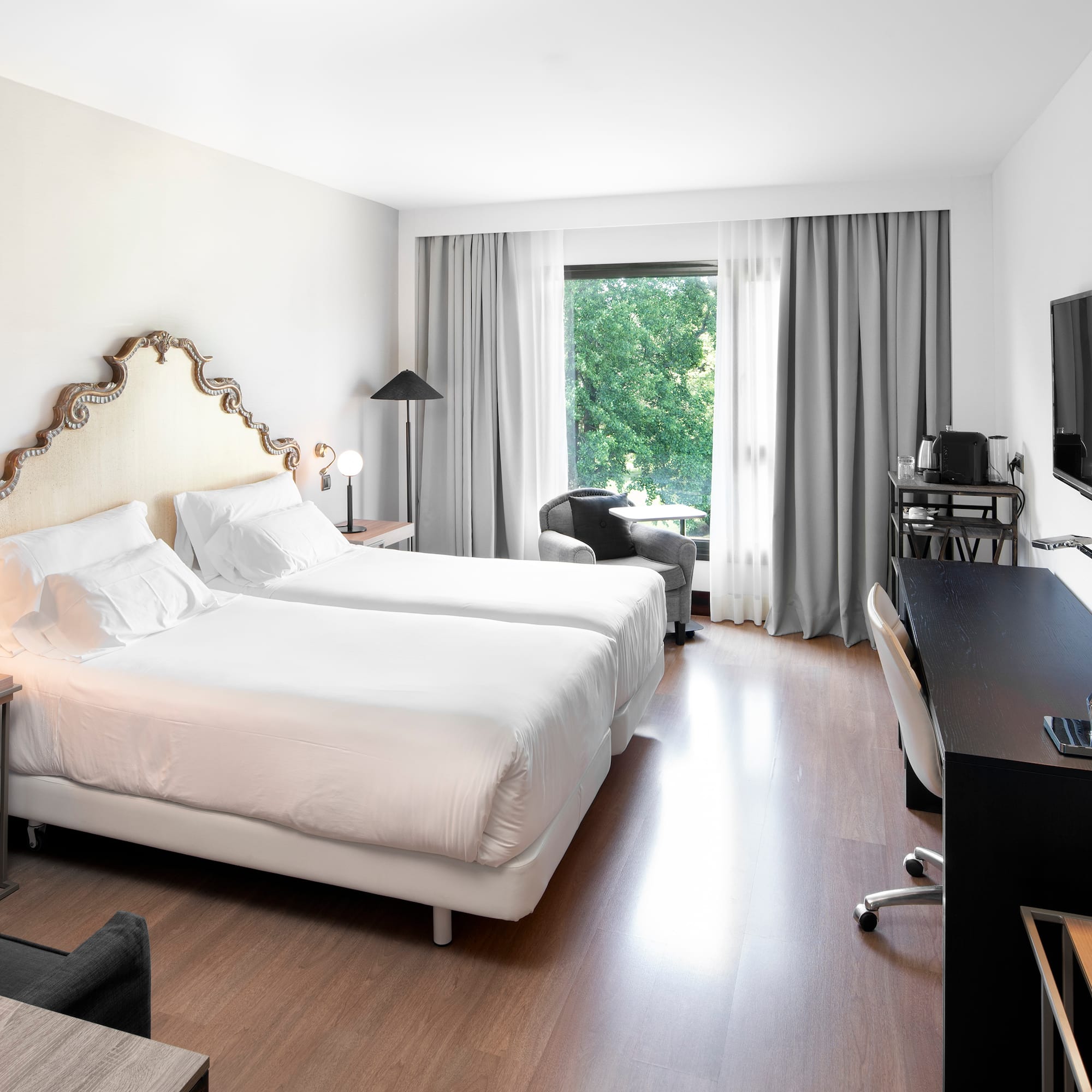 a room with two beds and a television