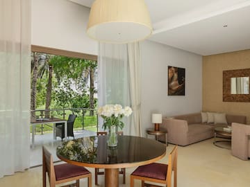 a living room with a table and chairs