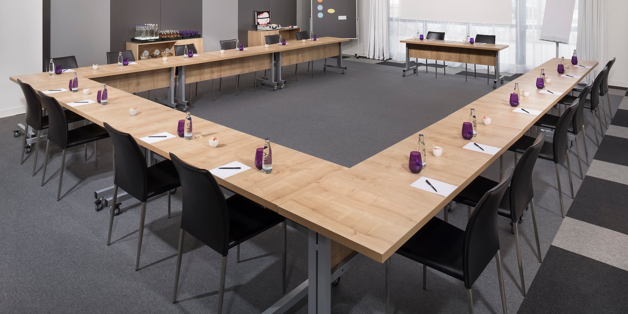 a conference room with a table and chairs