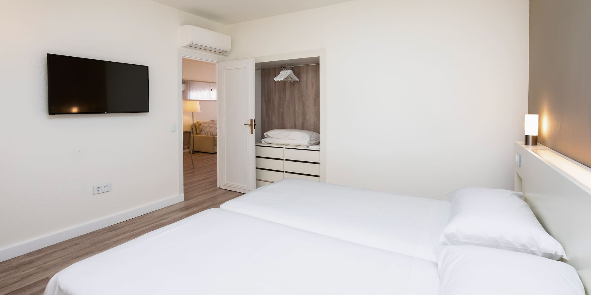 a bedroom with a tv and a bed