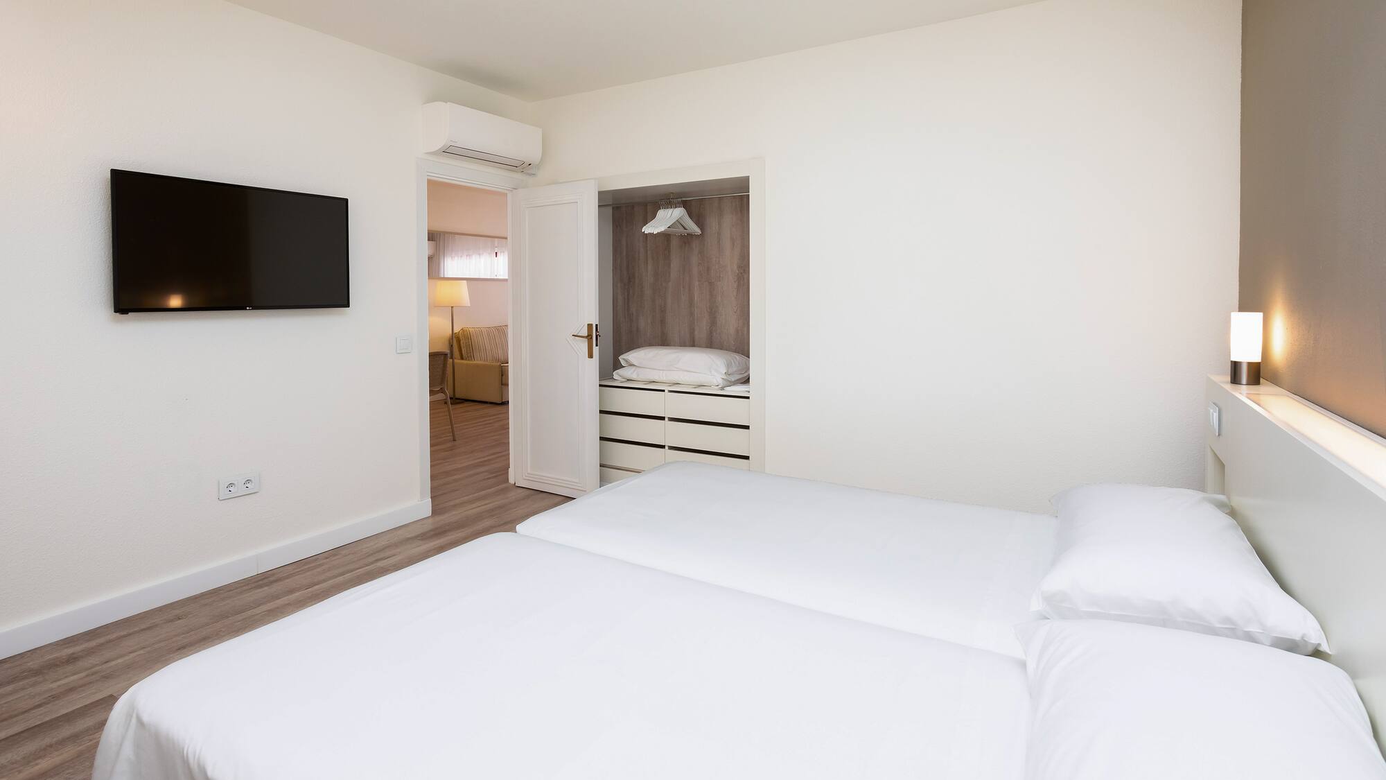 a bedroom with a tv and a bed