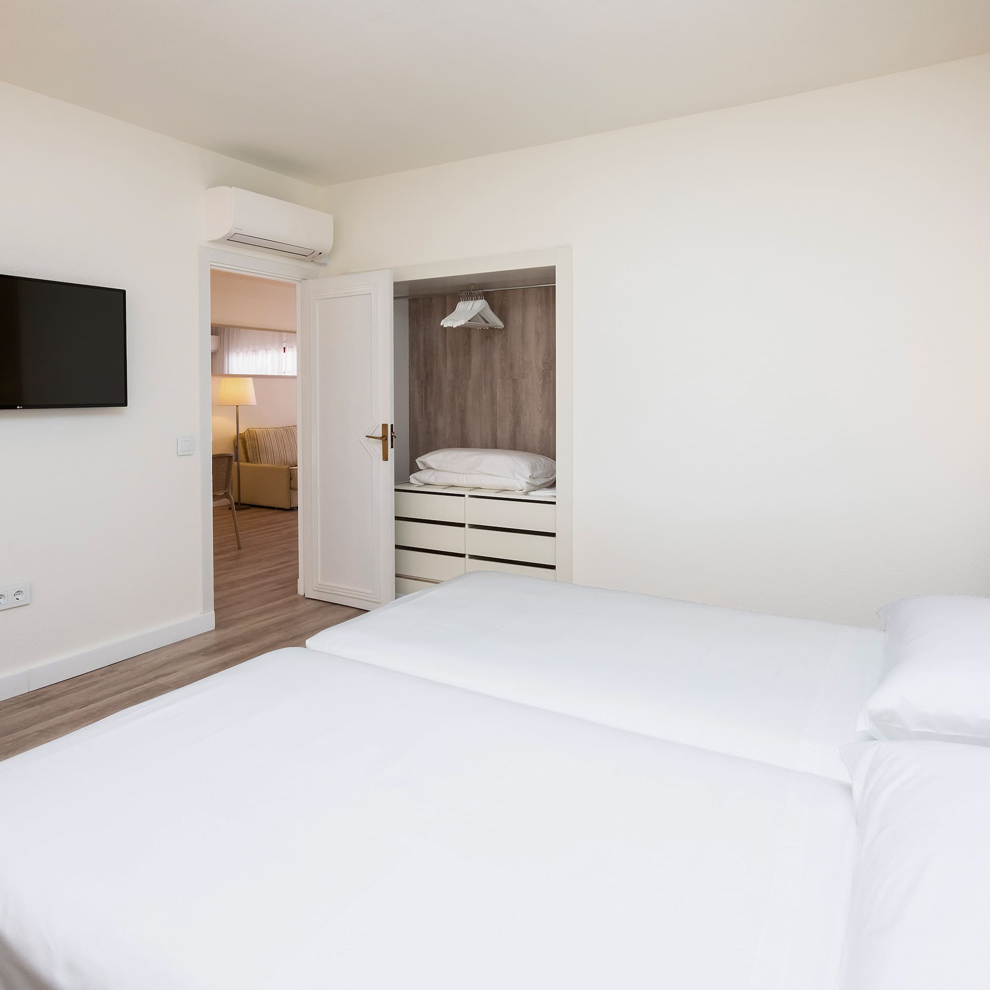 a bedroom with a tv and a bed