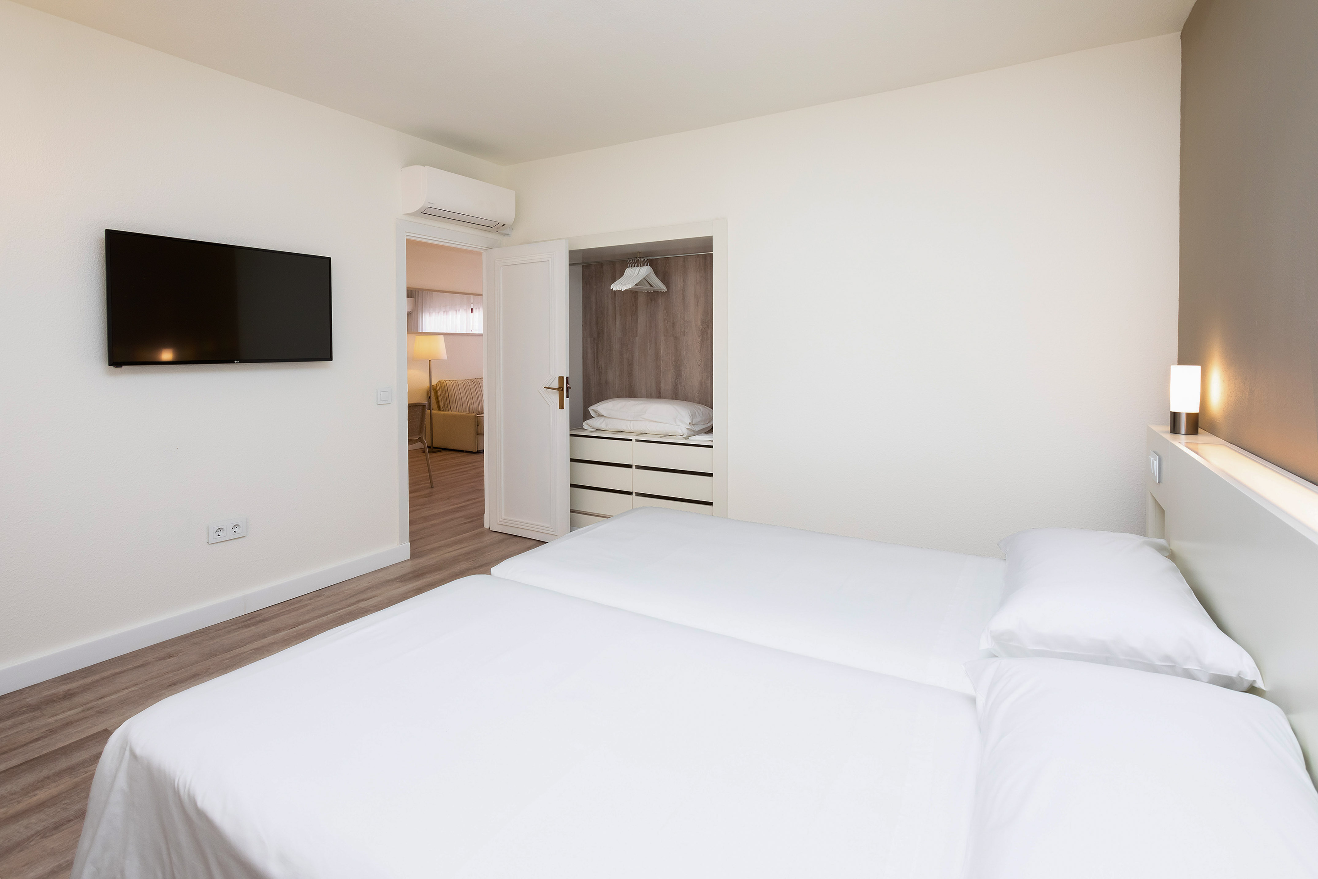 a bedroom with a tv and a bed