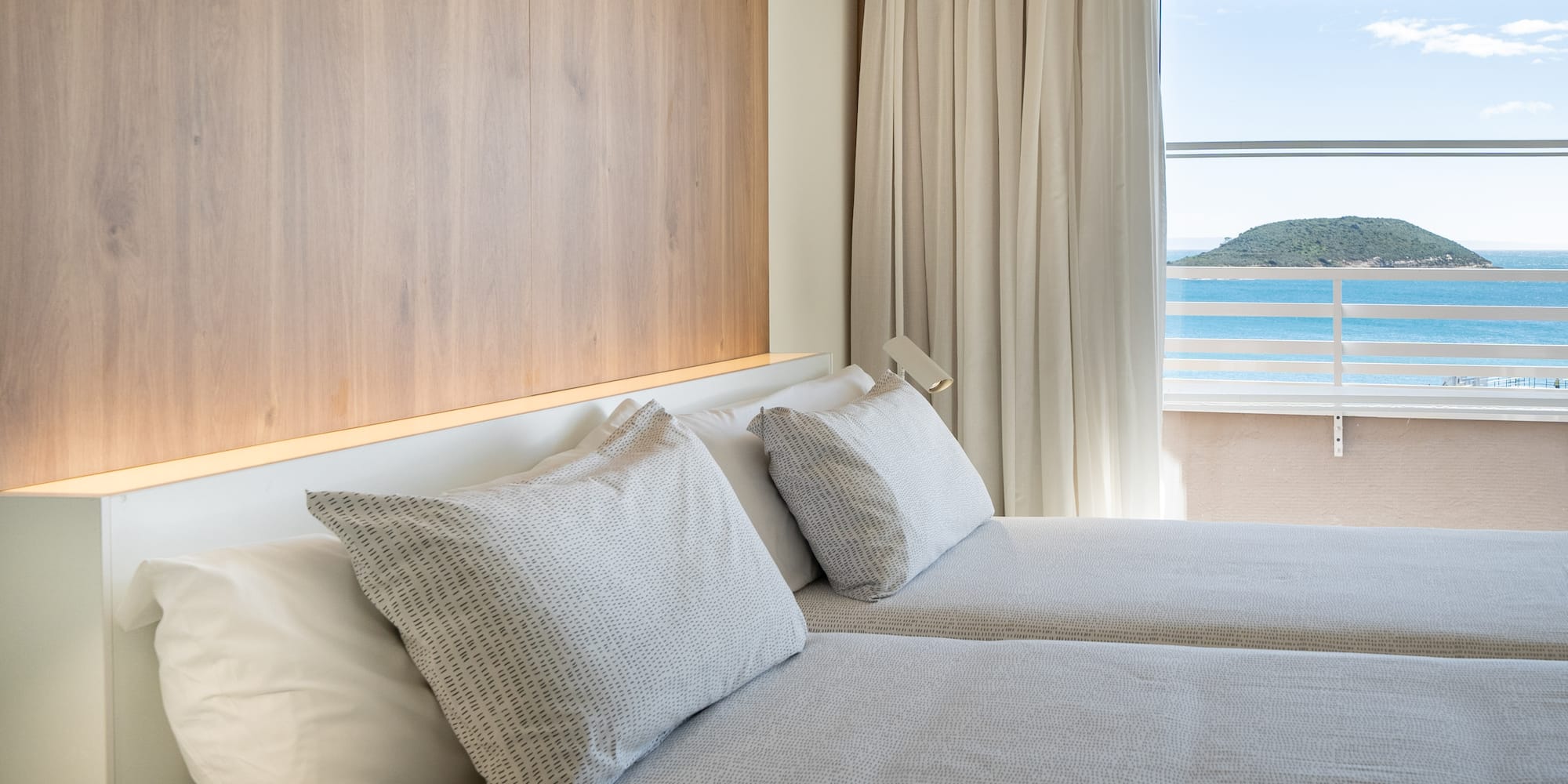 a room with two beds and a window