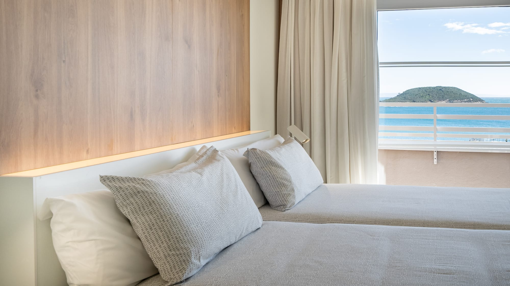 a room with two beds and a window