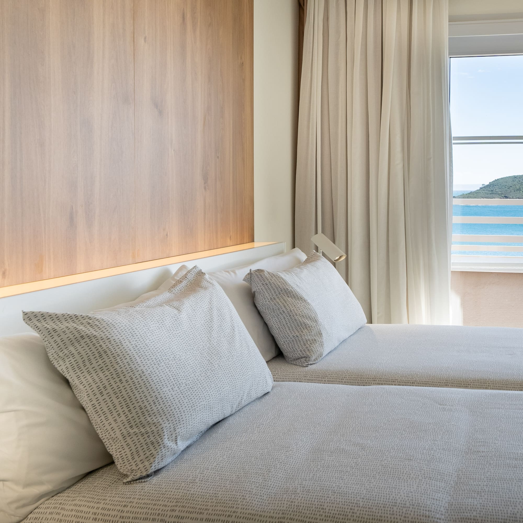 a room with two beds and a window