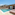 Modern hotel suite with private pool, sunbeds, and ocean view patio.
