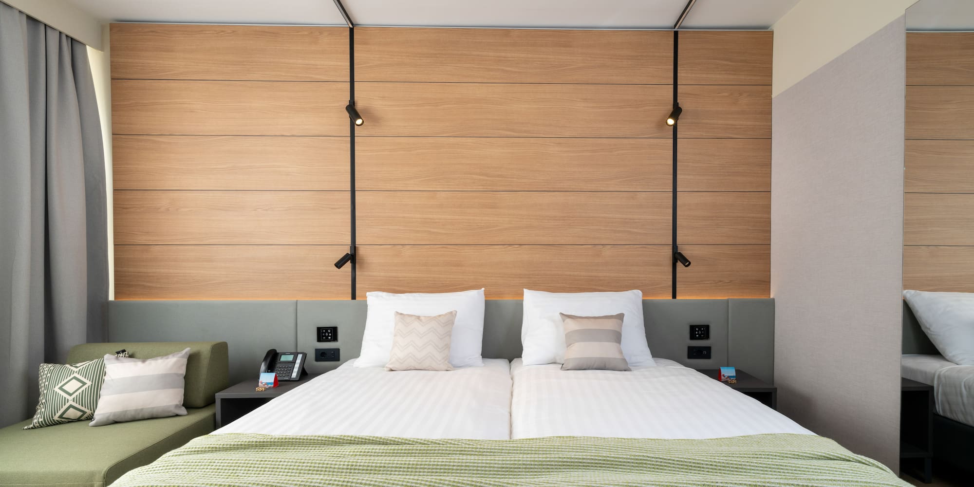 a bed with pillows and a green couch